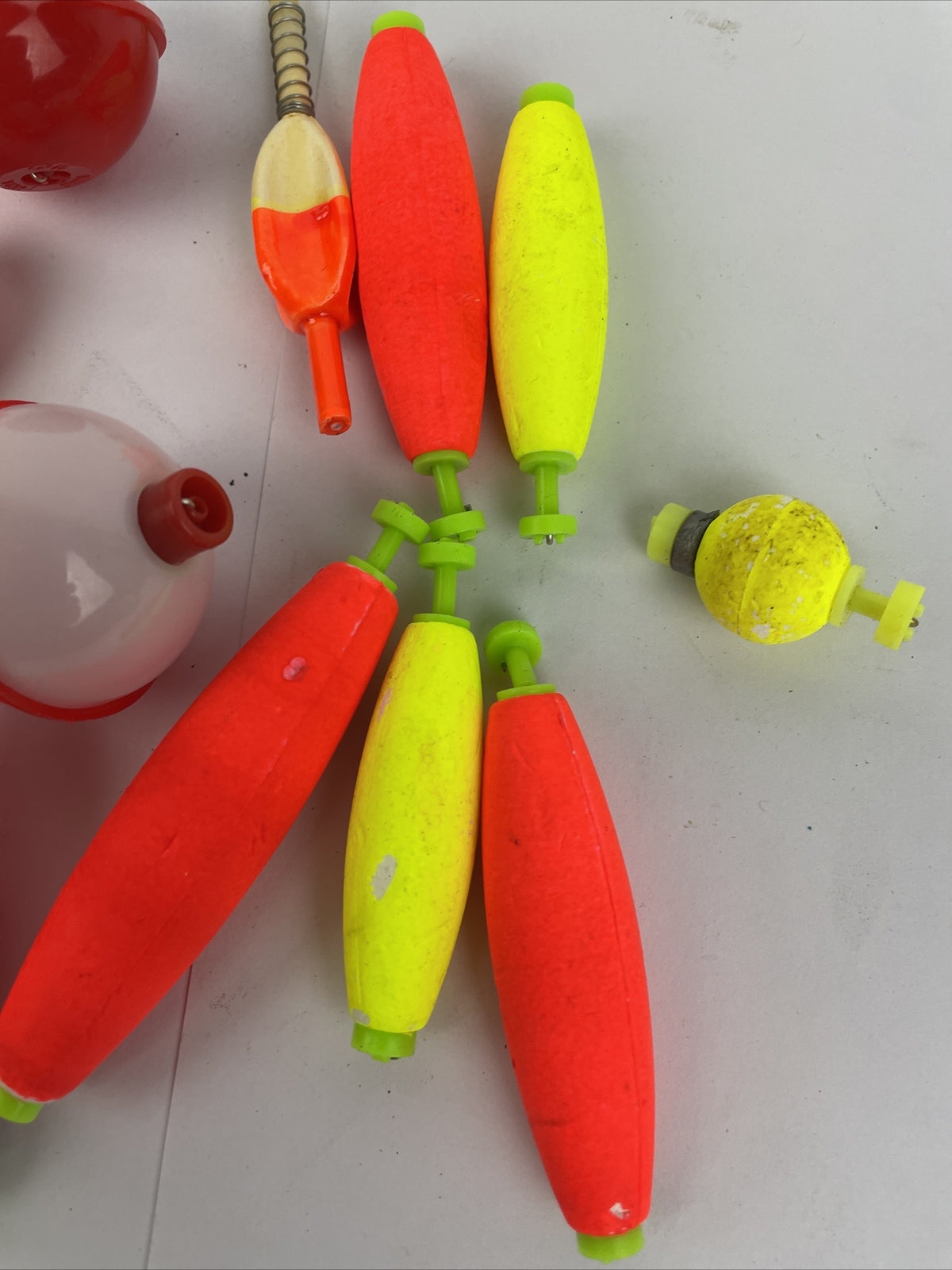 Lot of 16 round fishing bobbers in red white orange and yellow including Thill floats