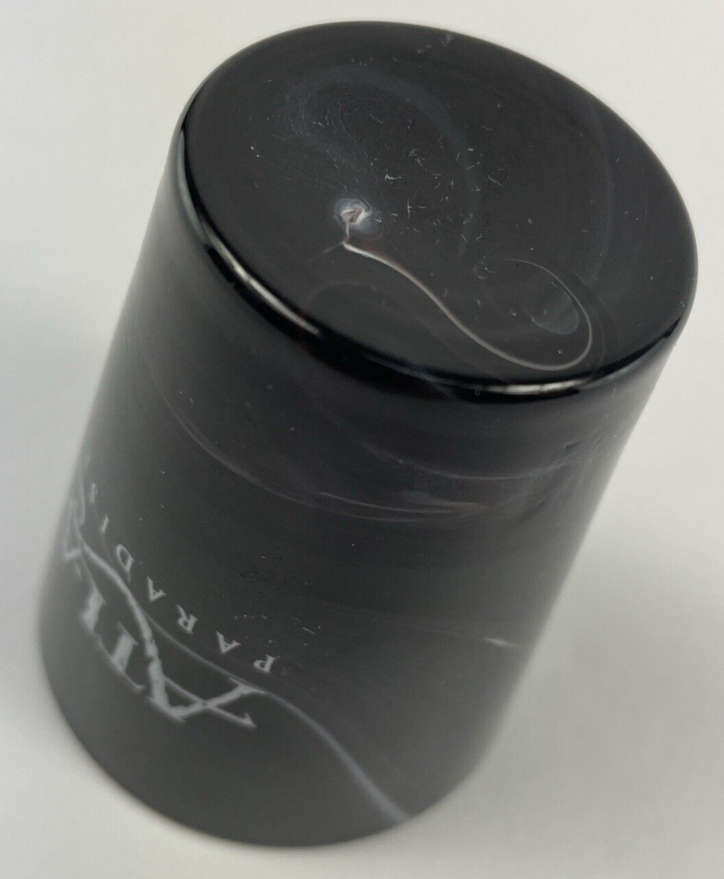 Atlantis Paradise Island black swirl glass souvenir shot glass.