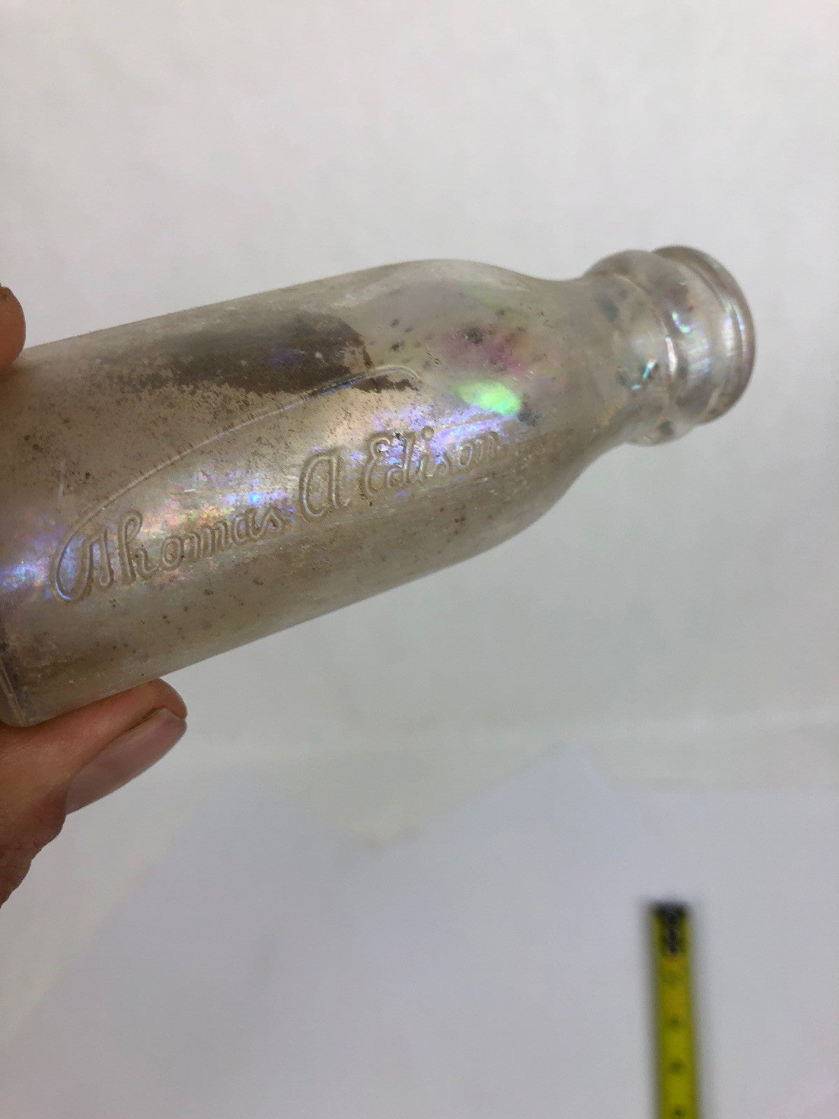 Rare vintage Thomas Edison Battery Oil clear glass bottle measuring 4⅛ inches.