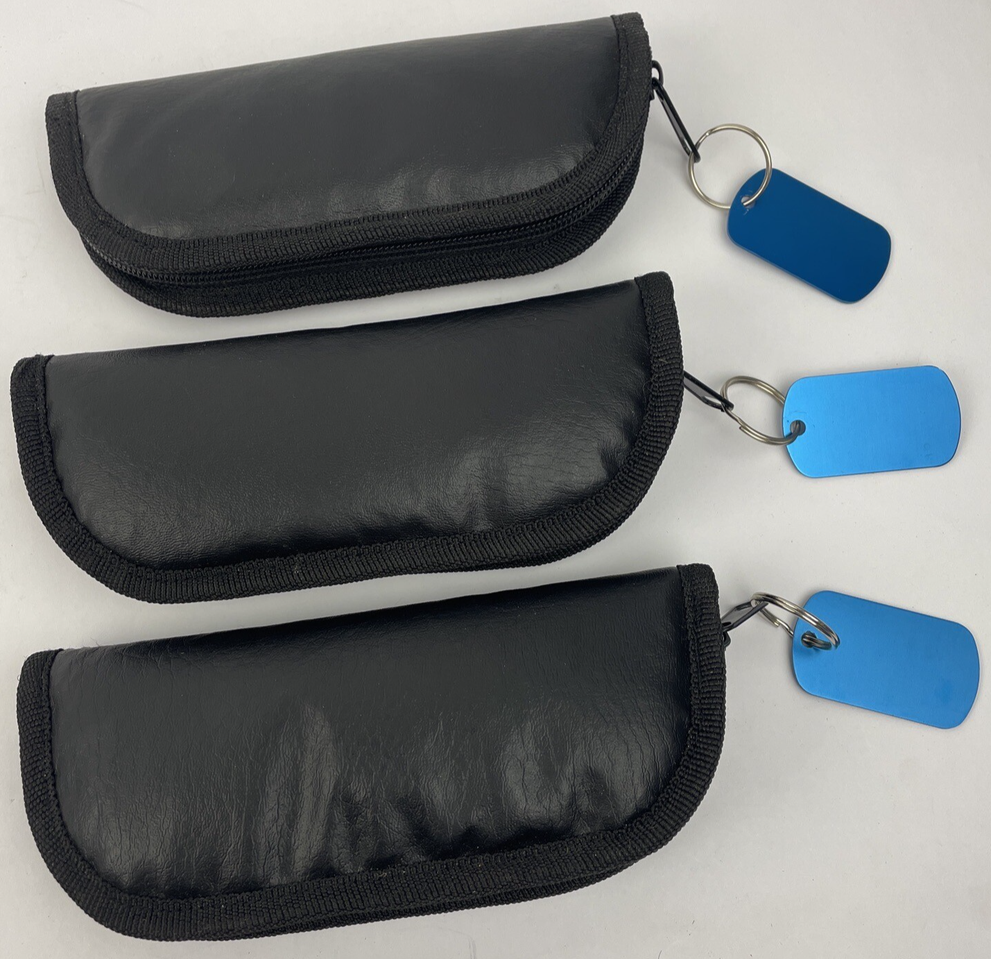 Lot of three black padded zippered storage pouches measuring 7 by 3 inches