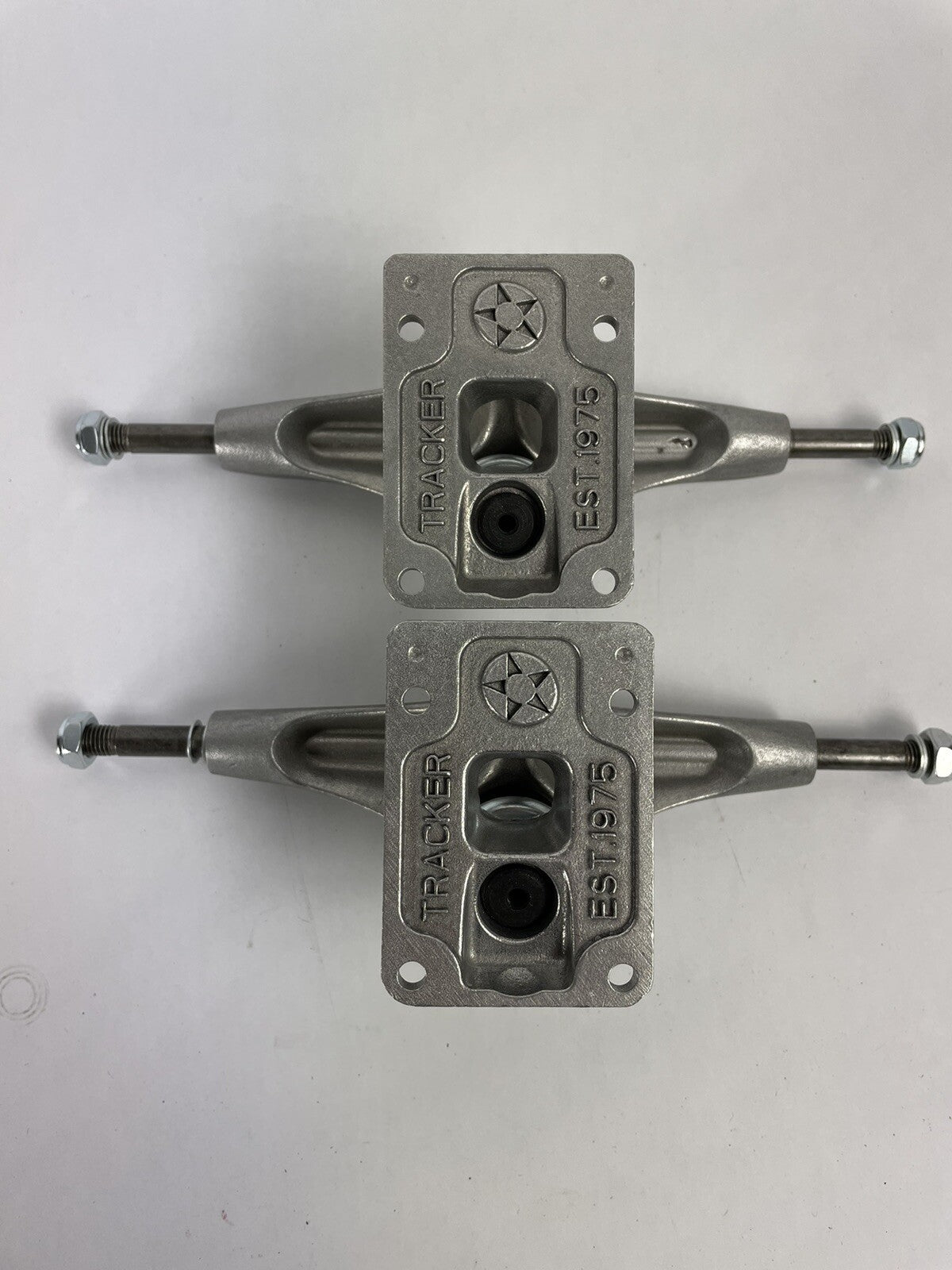 Tracker Axis polished skateboard trucks with 129mm axle, 5.0-inch hanger, and hollow kingpin for lightweight performance.