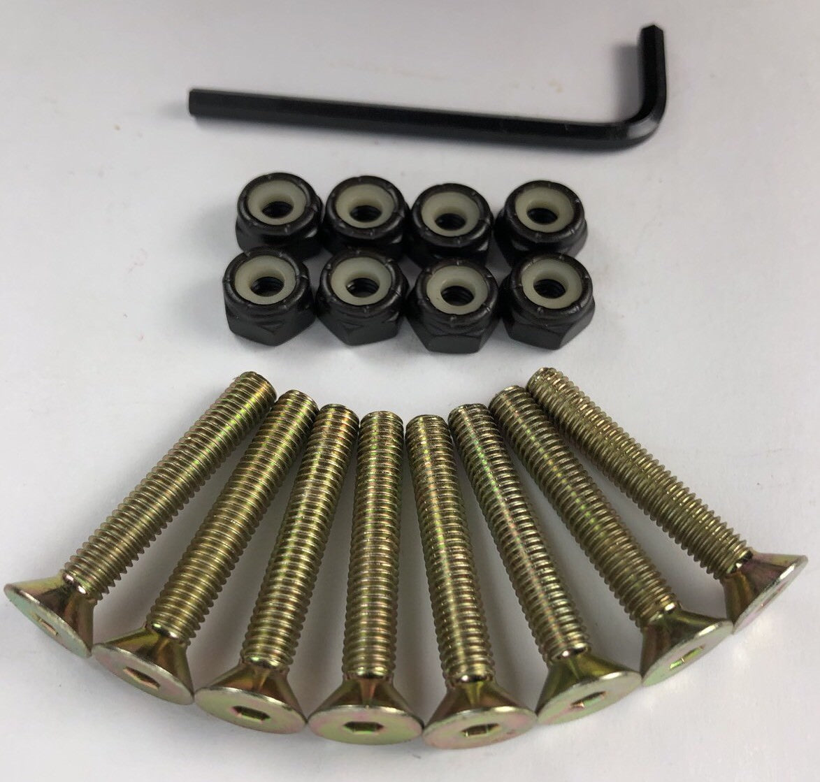 NOS Grind King Skateboards 1.25-inch gold Allen key skateboard mounting hardware set with hex-head bolts and nuts.