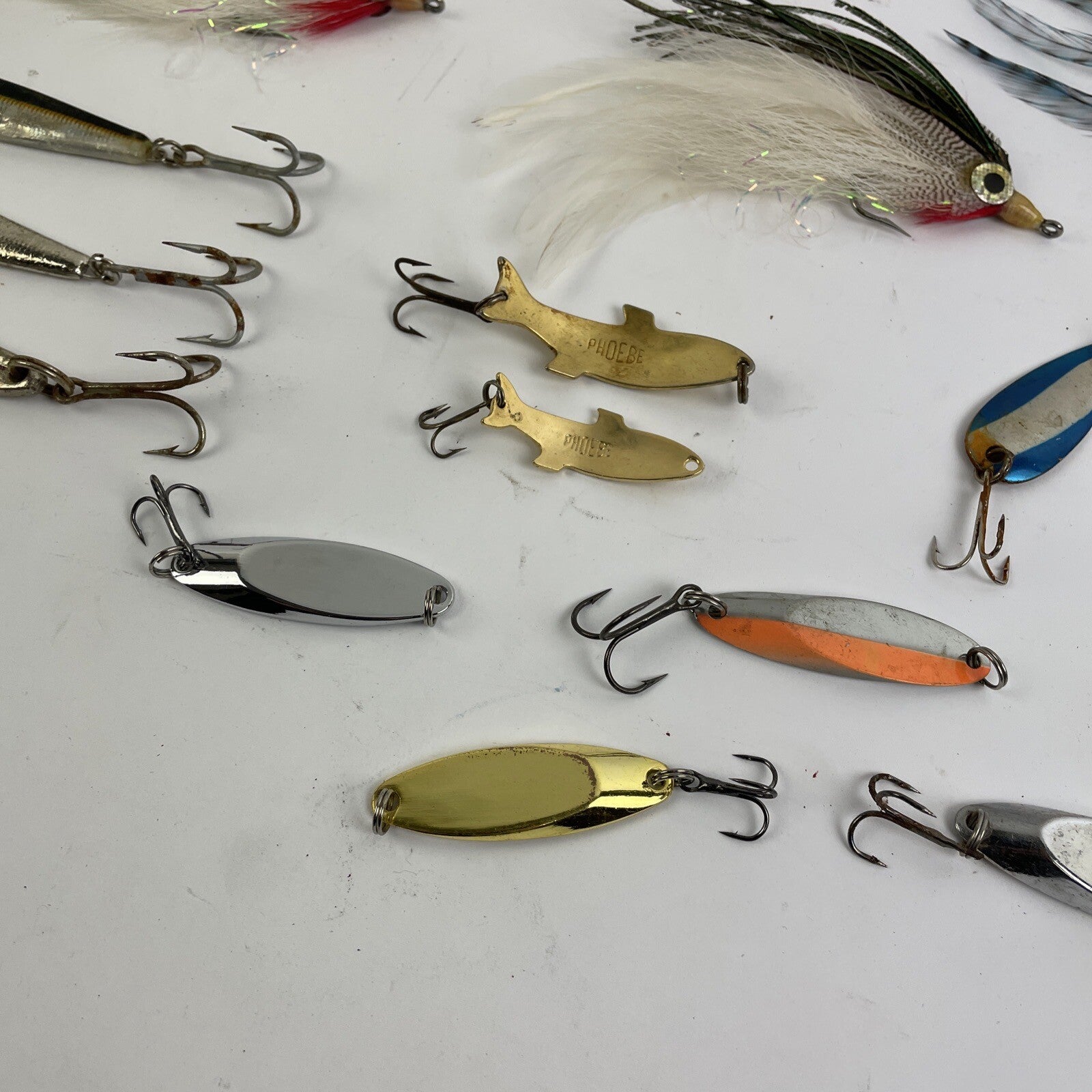 Lot of 22 assorted fishing spoons and spinners including Castmaster, Acme, and Phoebe lures.