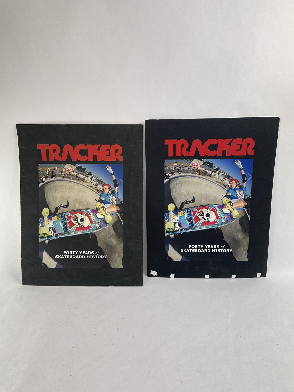 Set of two vintage Tracker Trucks trade show display books featuring Tony Hawk cover artwork.