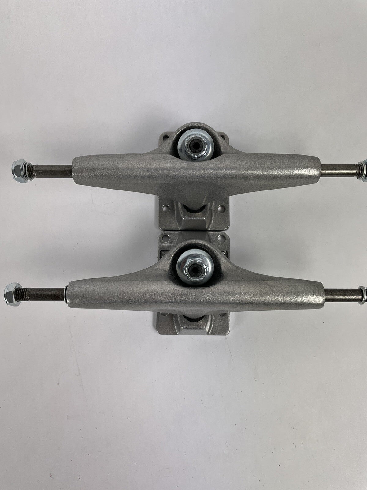 Tracker Axis polished skateboard trucks with 129mm axle, 5.0-inch hanger, and hollow kingpin for lightweight performance.