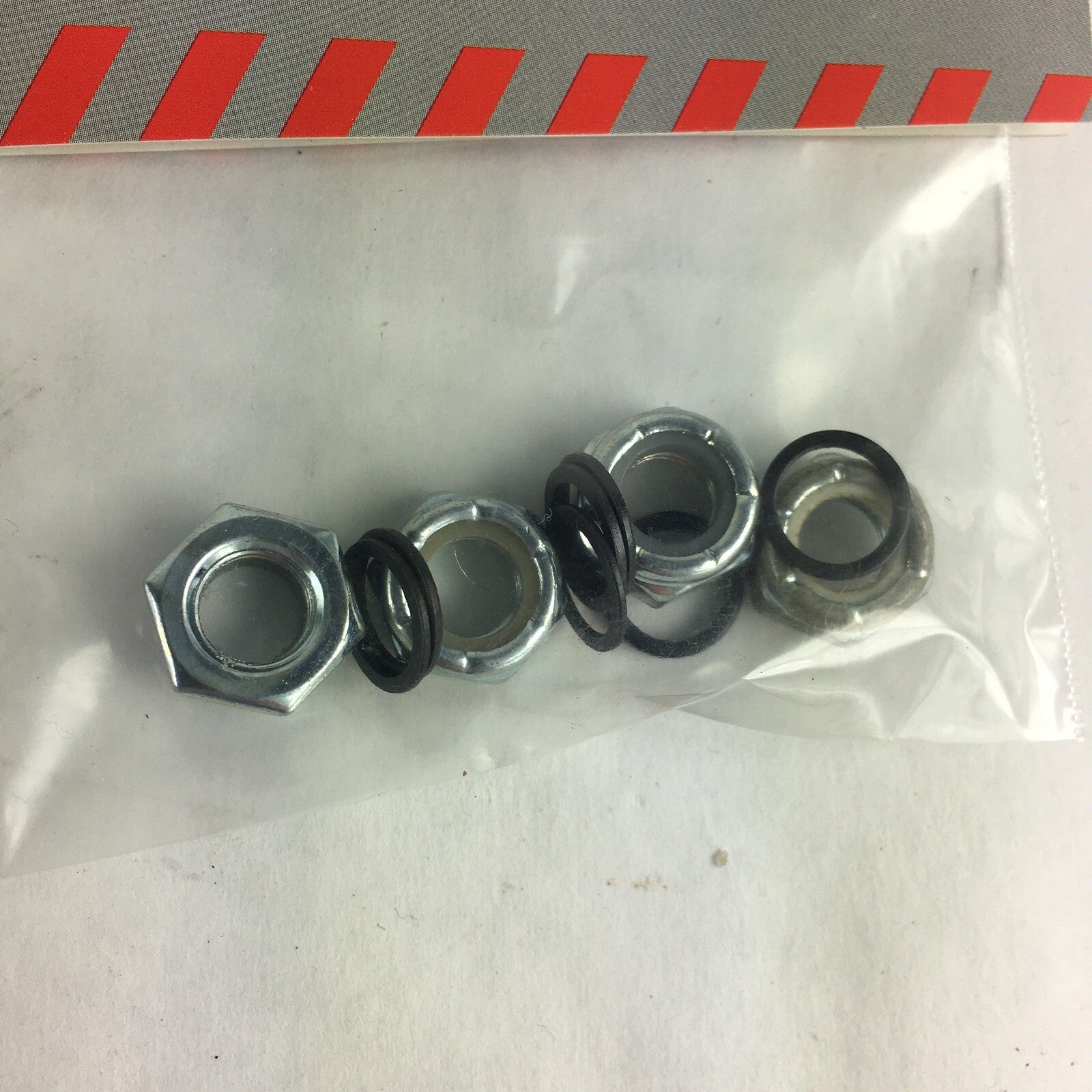 Grind King skateboard truck axle hardware kit with lock nuts, washers, and speed rings for truck maintenance and wheel installation.