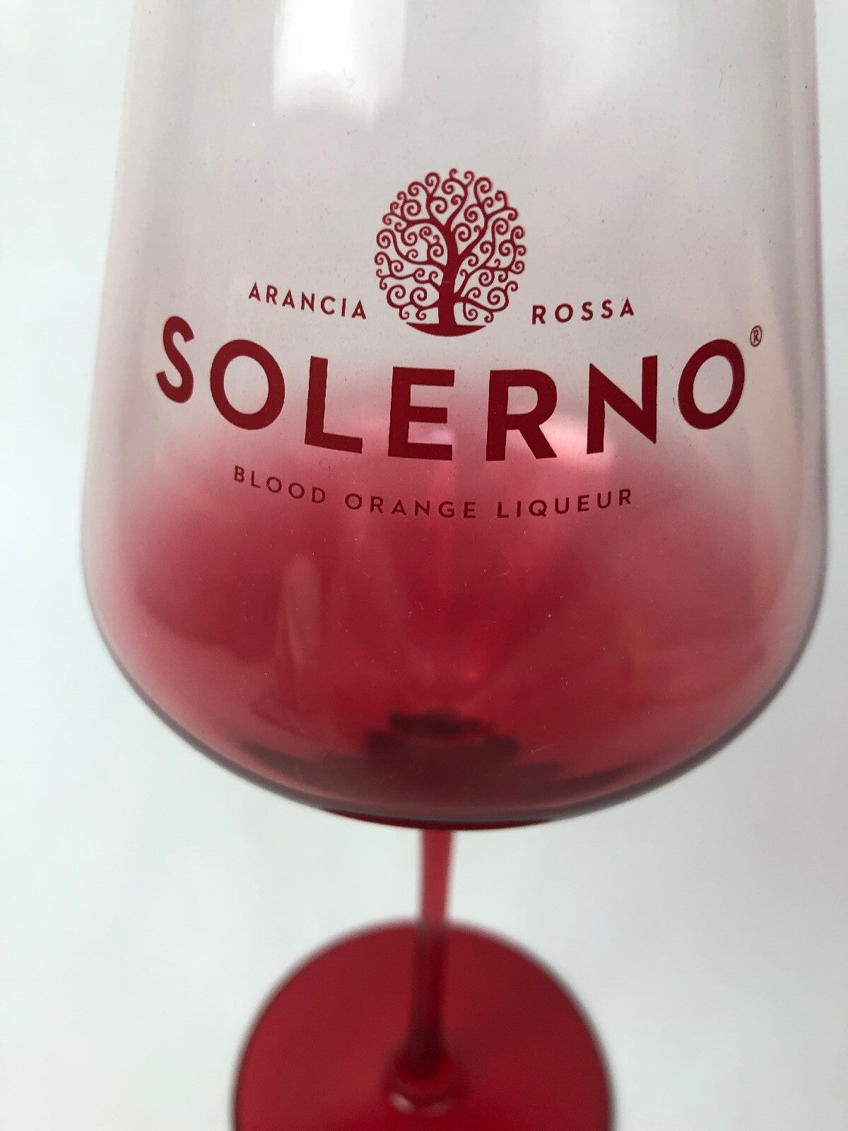 Set of two rare Solerno Blood Orange Liqueur long stem wine glasses.