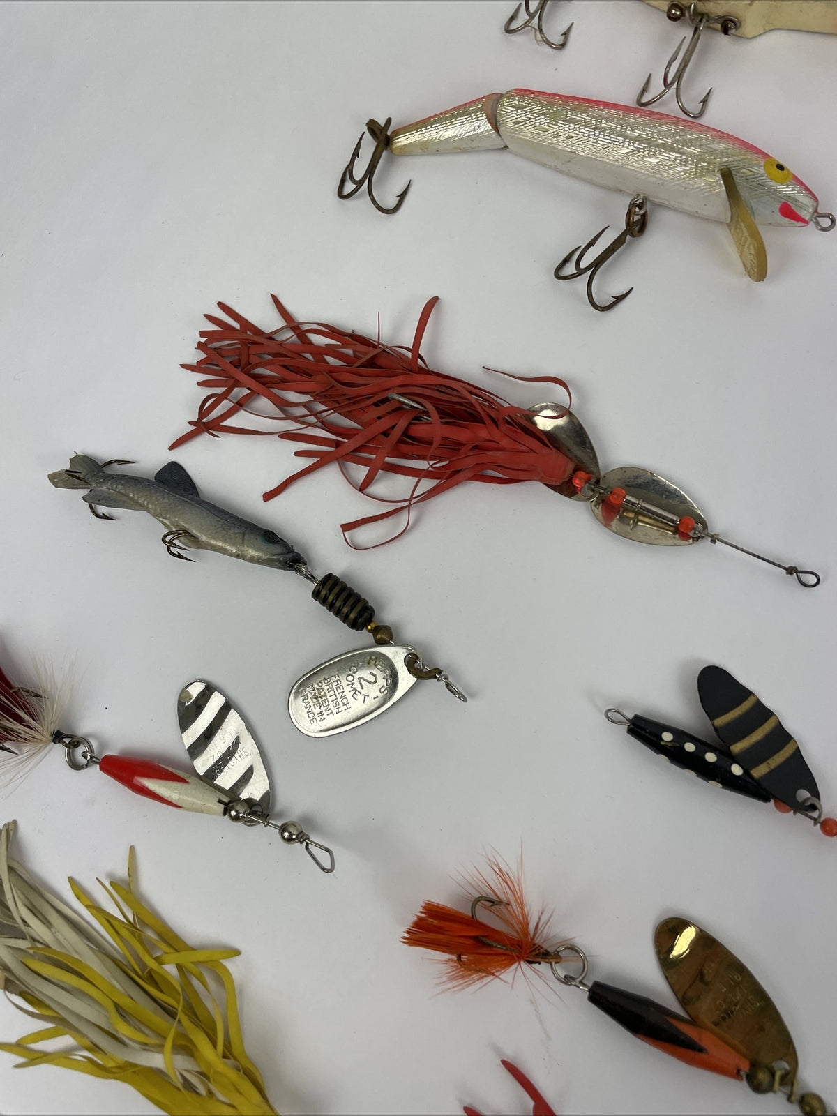 Vintage fishing lure lot with Jitterbug Rebel Floater Mepps and Shyster lures for trout crappie and bass fishing