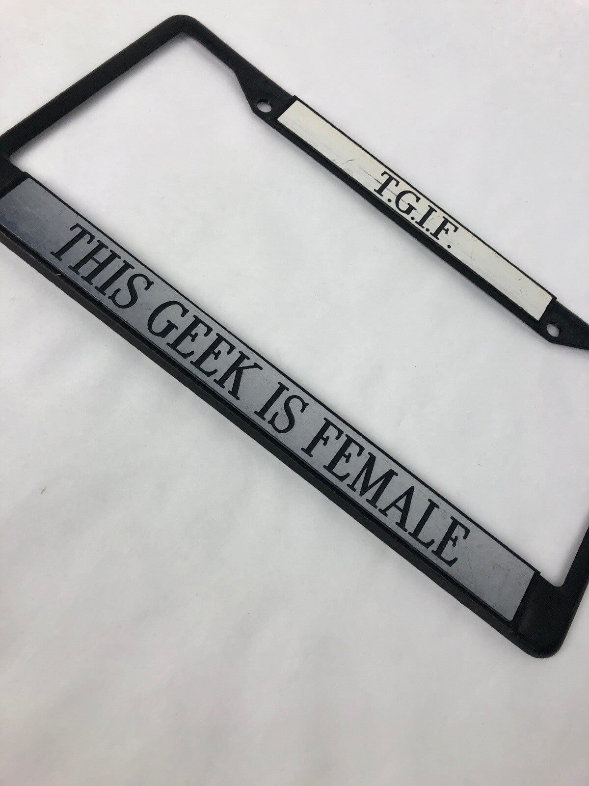 T.G.I.F. This Geek Is Female funny novelty license plate frame tailgate tag cover for standard vehicle license plates.