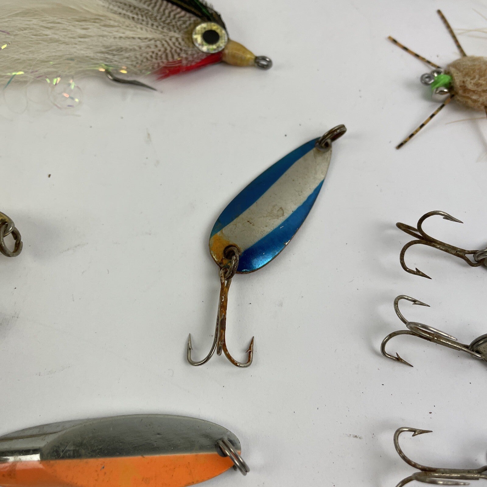 Lot of 22 assorted fishing spoons and spinners including Castmaster, Acme, and Phoebe lures.