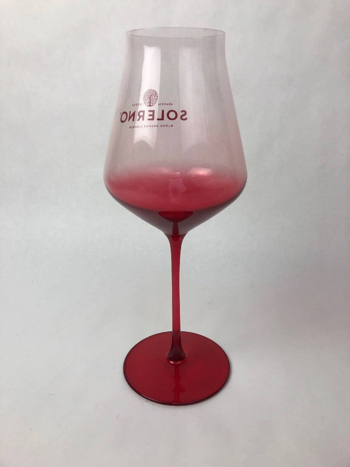 Set of two rare Solerno Blood Orange Liqueur long stem wine glasses.