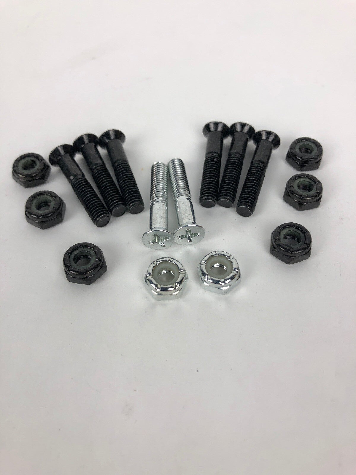 NOS Grind King 1-inch Phillips skateboard hardware set with silver bolts and lock nuts in Silverado finish.