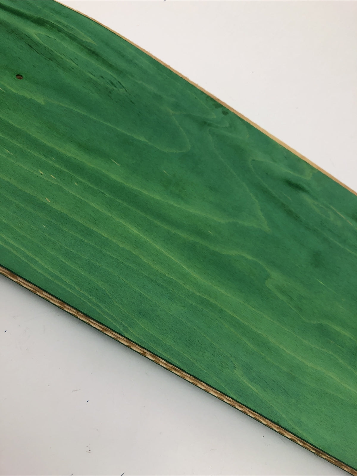 Blank uncut 10 x 34-inch green stain skateboard deck with 14.25-inch wheelbase.
