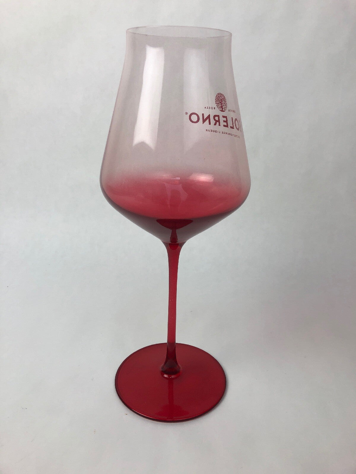 Set of two rare Solerno Blood Orange Liqueur long stem wine glasses.