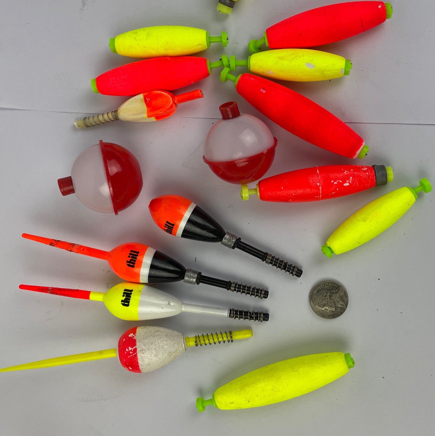 Lot of 16 round fishing bobbers in red white orange and yellow including Thill floats