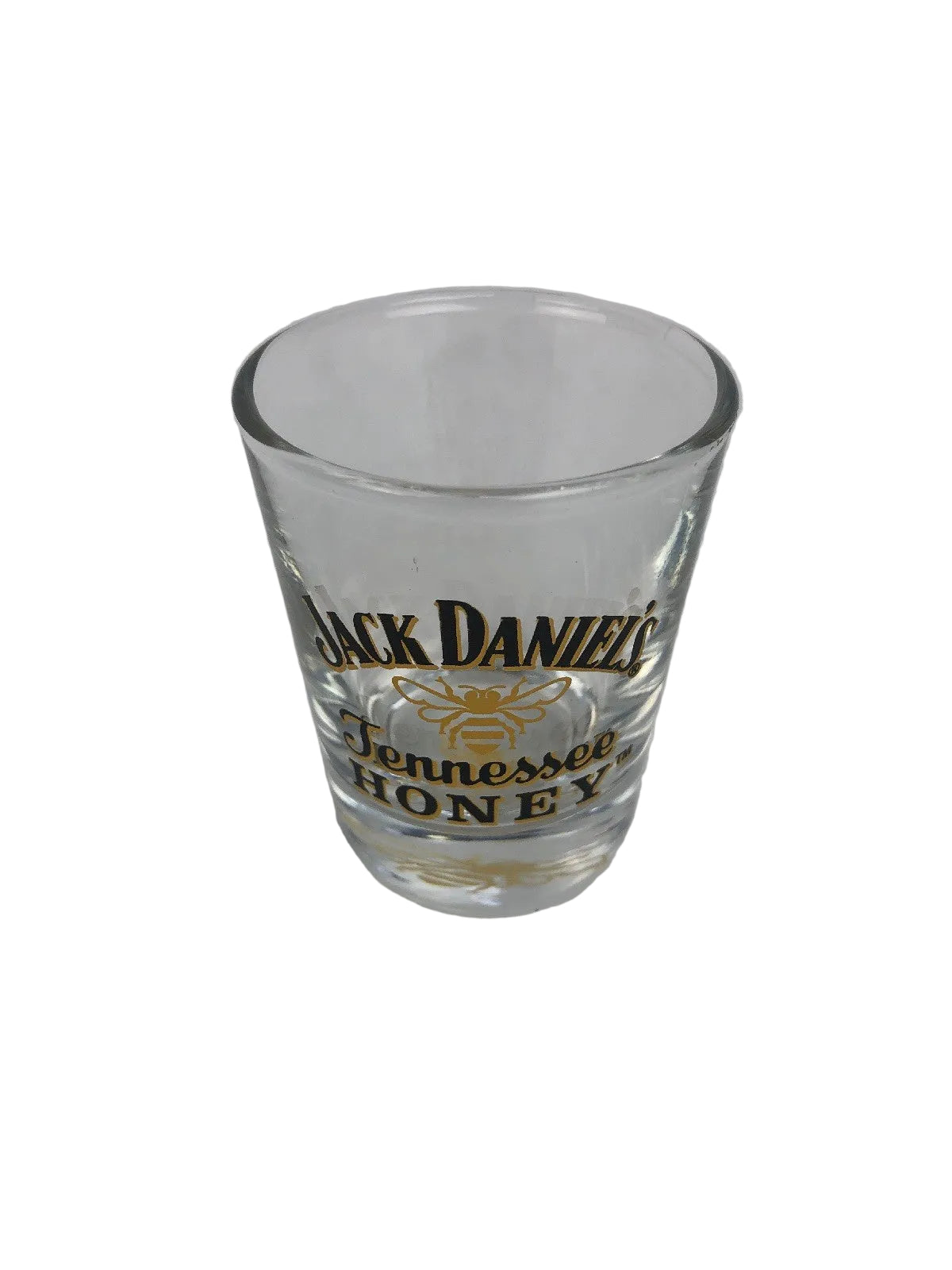 Jack Daniel's Tennessee Honey clear shot glass with gold honey bee design.