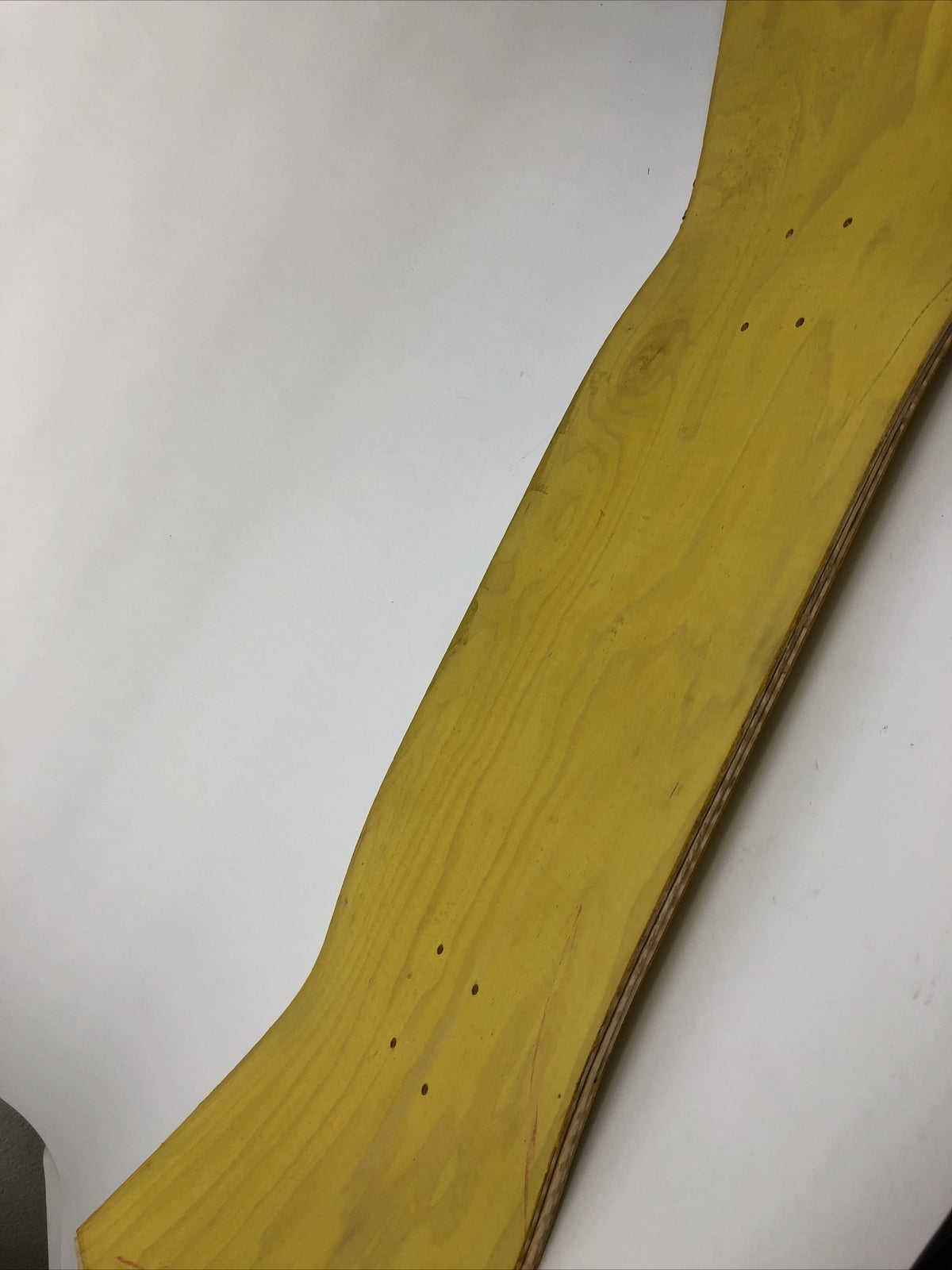Blank uncut 10 x 34-inch yellow stain skateboard deck with 14.25-inch wheelbase.