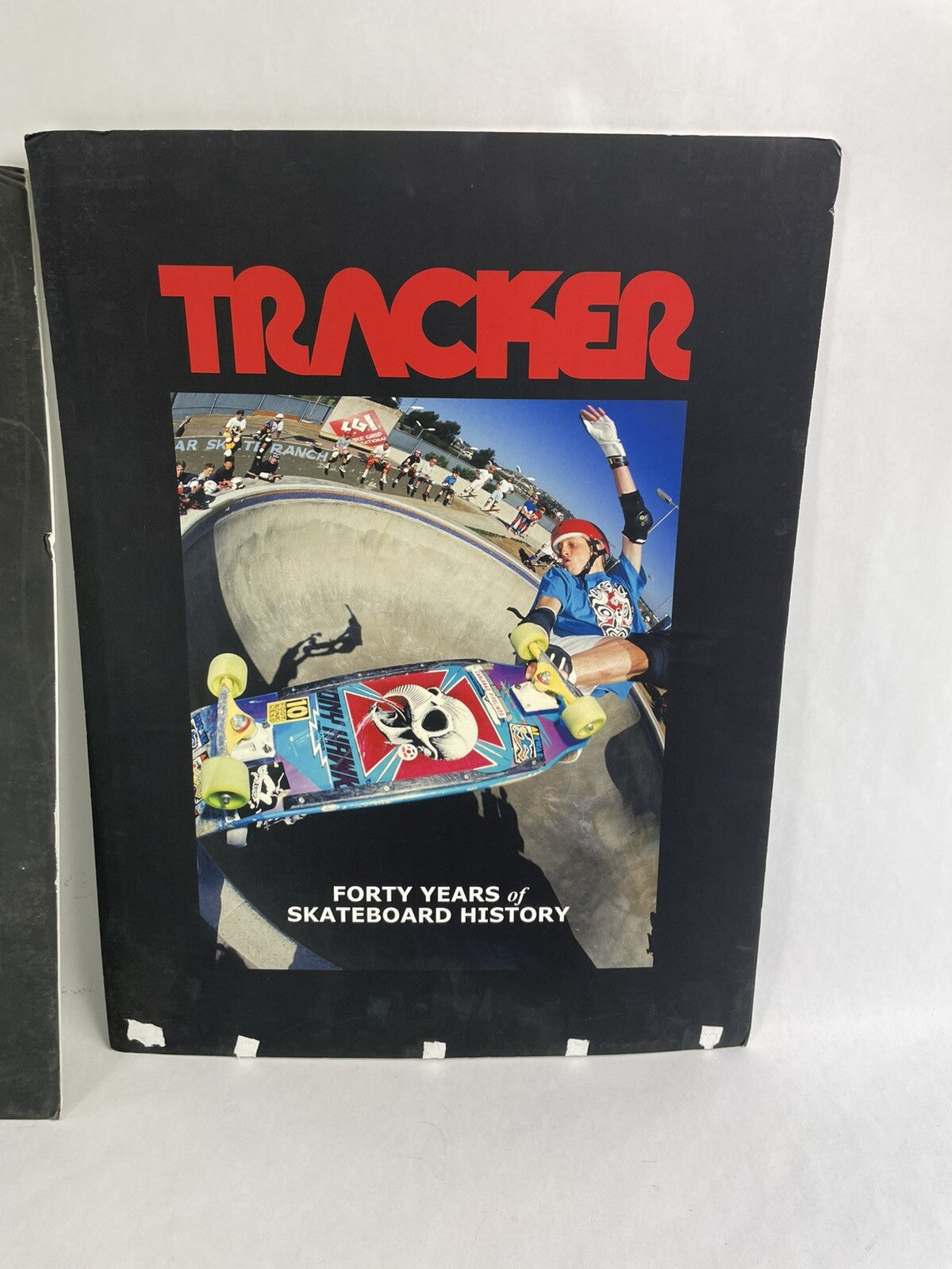 Set of two vintage Tracker Trucks trade show display books featuring Tony Hawk cover artwork.