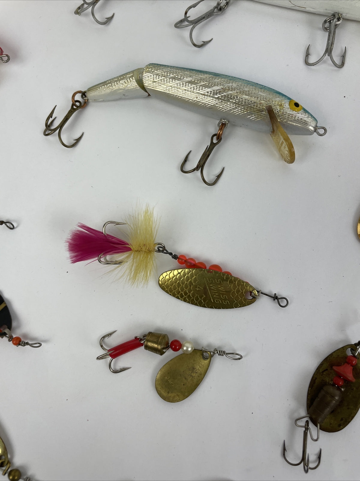 Vintage fishing lure lot with Jitterbug Rebel Floater Mepps and Shyster lures for trout crappie and bass fishing