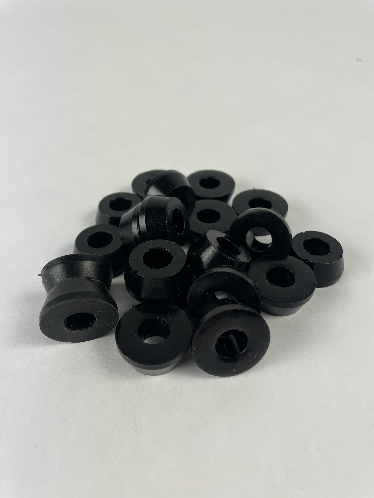 Black skateboard truck upper replacement bushings bulk kit with 20 polyurethane pieces for standard skateboard trucks.