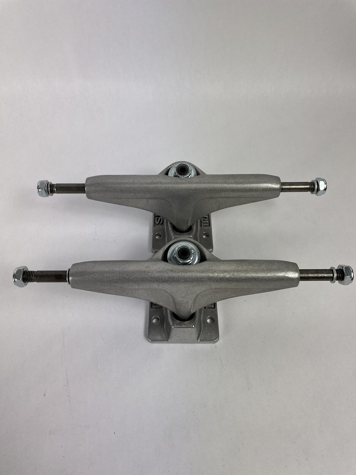 Pair of Tracker Axis 139mm polished skateboard trucks with 8.25-inch axle width and hollow kingpin for street and park skating.