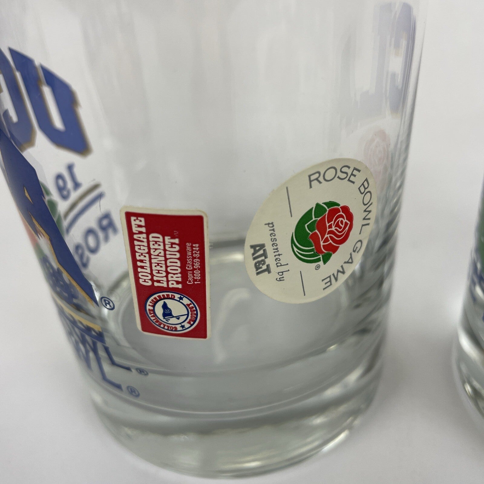 Set of two vintage UCLA Rose Bowl 1999 blue print bar glasses with gold trim.