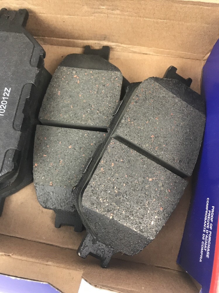 NAPA SS7787X front ceramic disc brake pad set OEM replacement brake pads with anti-squeal shims for automotive front disc brake systems.