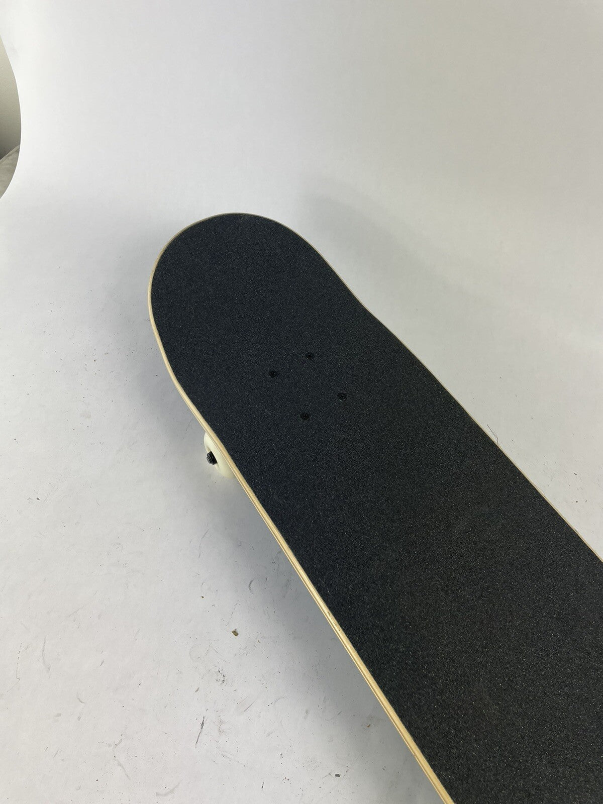 Blue blank 8-inch complete skateboard with gravity cast trucks, 52mm ATM wheels, and ABEC 7 bearings.