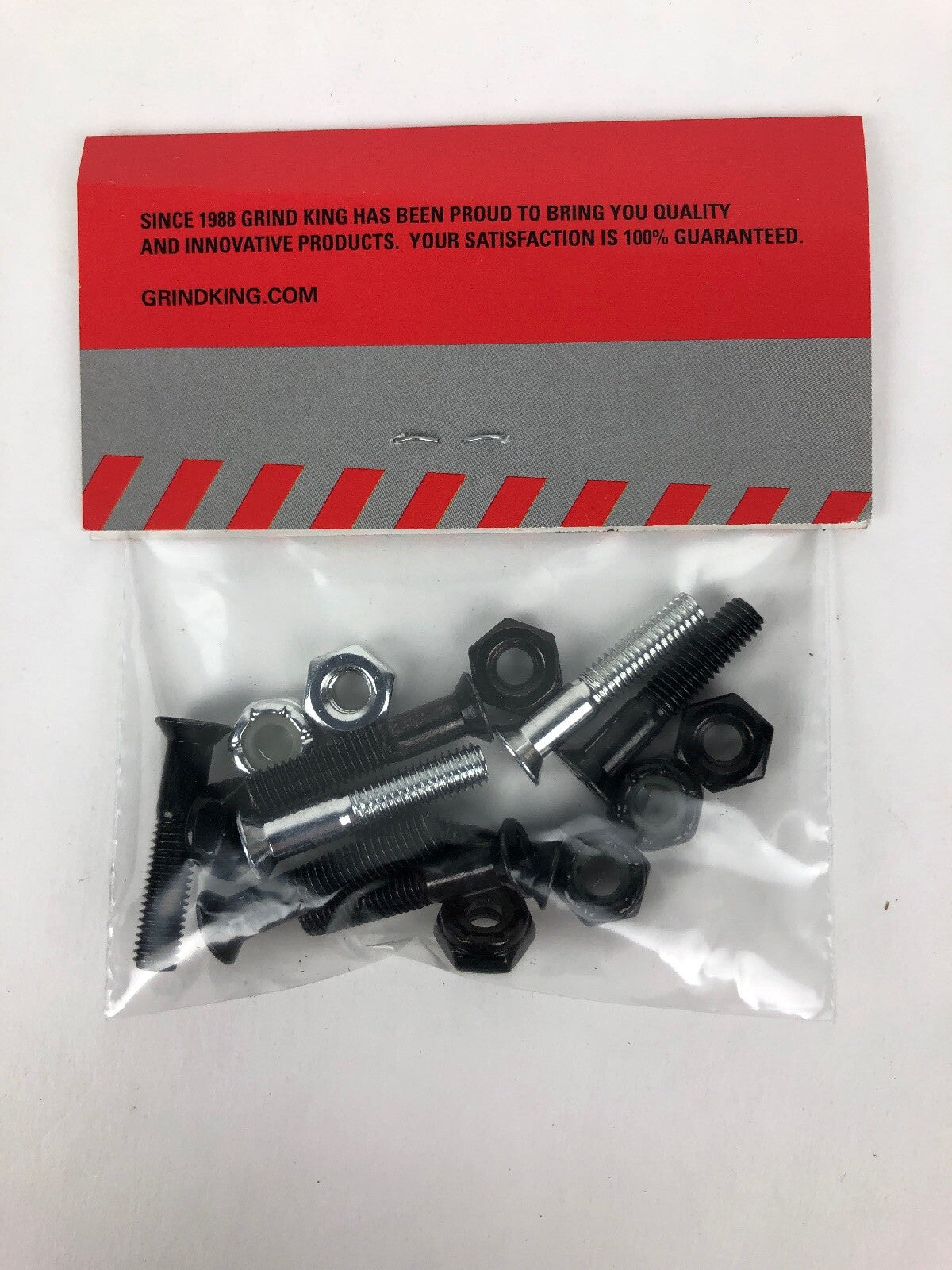 NOS Grind King 1-inch Phillips skateboard hardware set with silver bolts and lock nuts in Silverado finish.