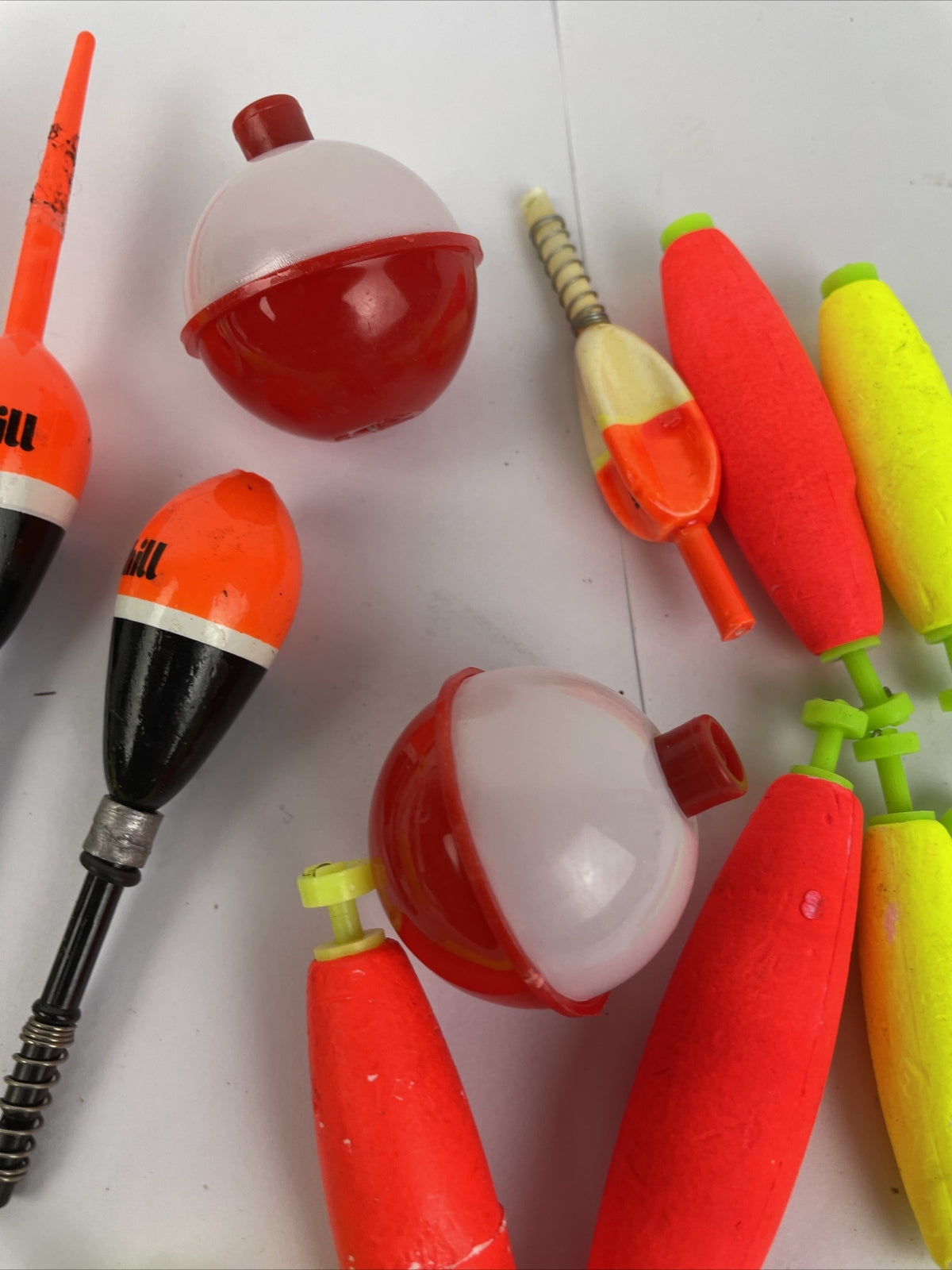 Lot of 16 round fishing bobbers in red white orange and yellow including Thill floats