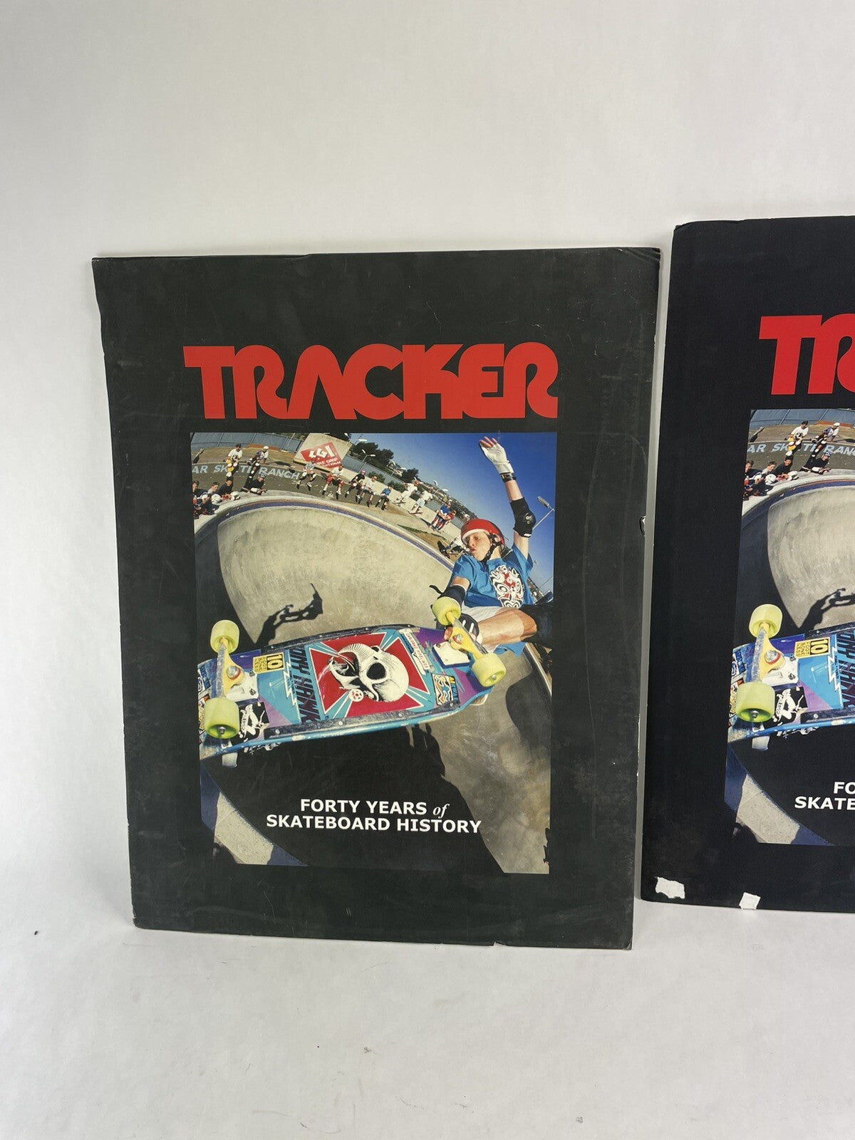 Set of two vintage Tracker Trucks trade show display books featuring Tony Hawk cover artwork.