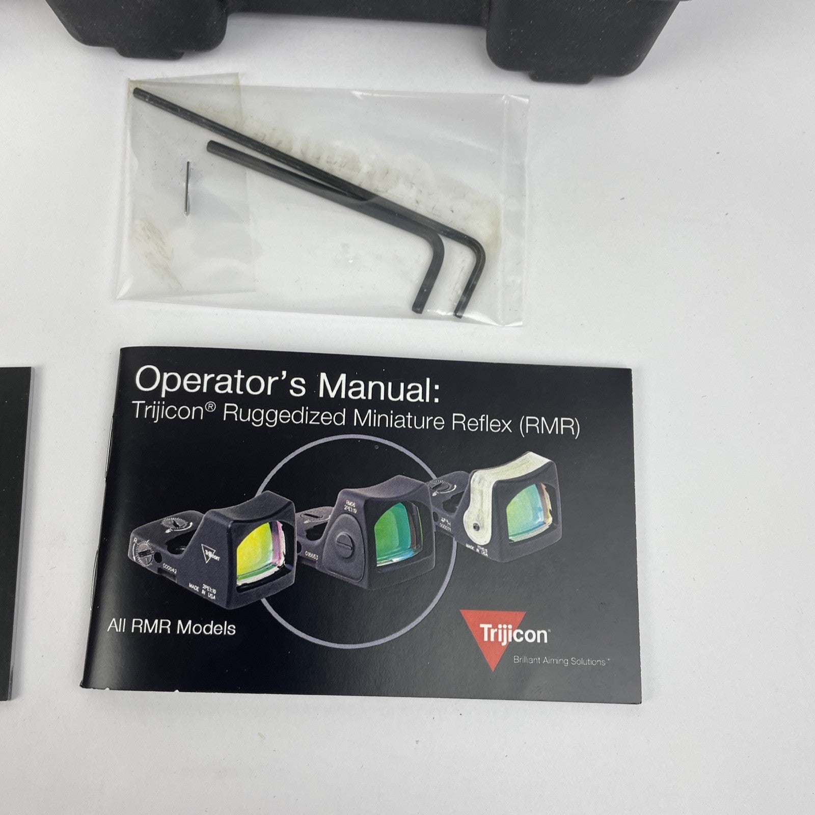 Trijicon OEM hard travel case with foam insert measuring 5.5 x 5 inches