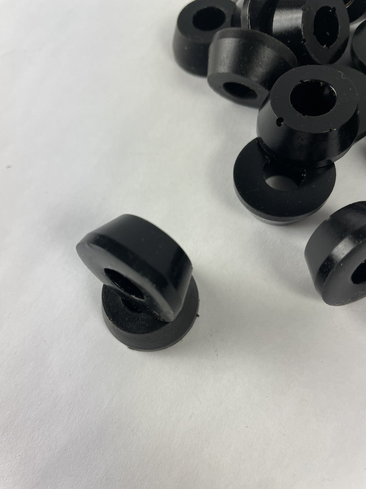 Black skateboard truck upper replacement bushings bulk kit with 20 polyurethane pieces for standard skateboard trucks.
