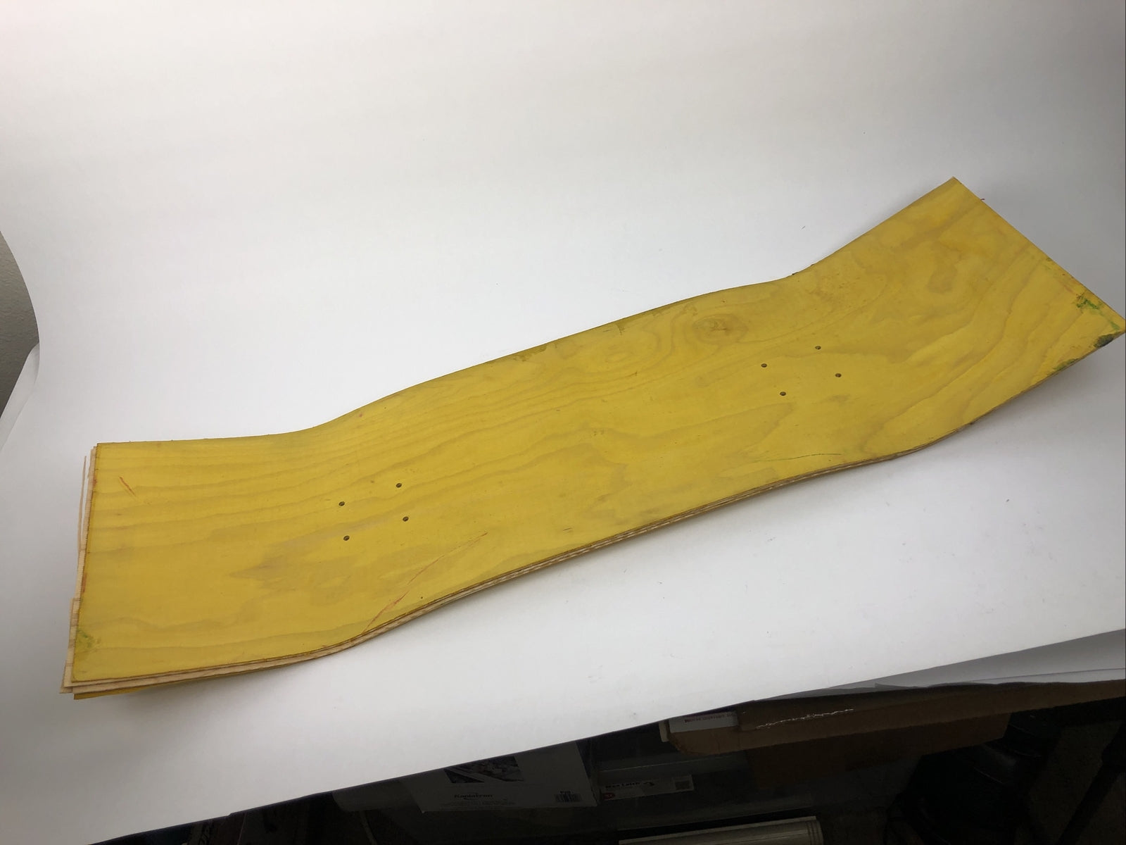 Blank uncut 10 x 34-inch yellow stain skateboard deck with 14.25-inch wheelbase.