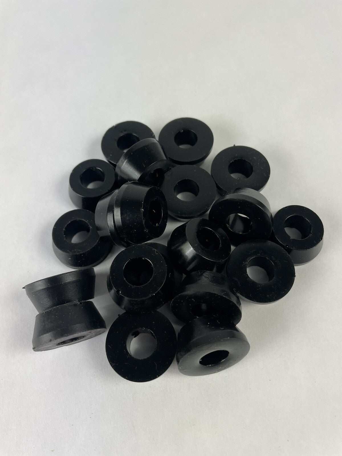 Black skateboard truck upper replacement bushings bulk kit with 20 polyurethane pieces for standard skateboard trucks.