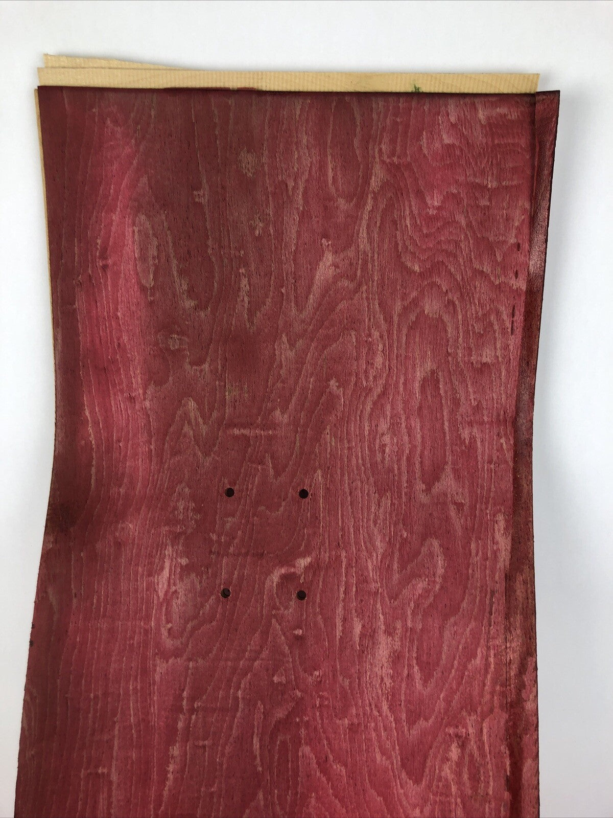 Blank uncut red stain skateboard deck 10 x 34 inches with 14.25-inch pre-drilled wheelbase.