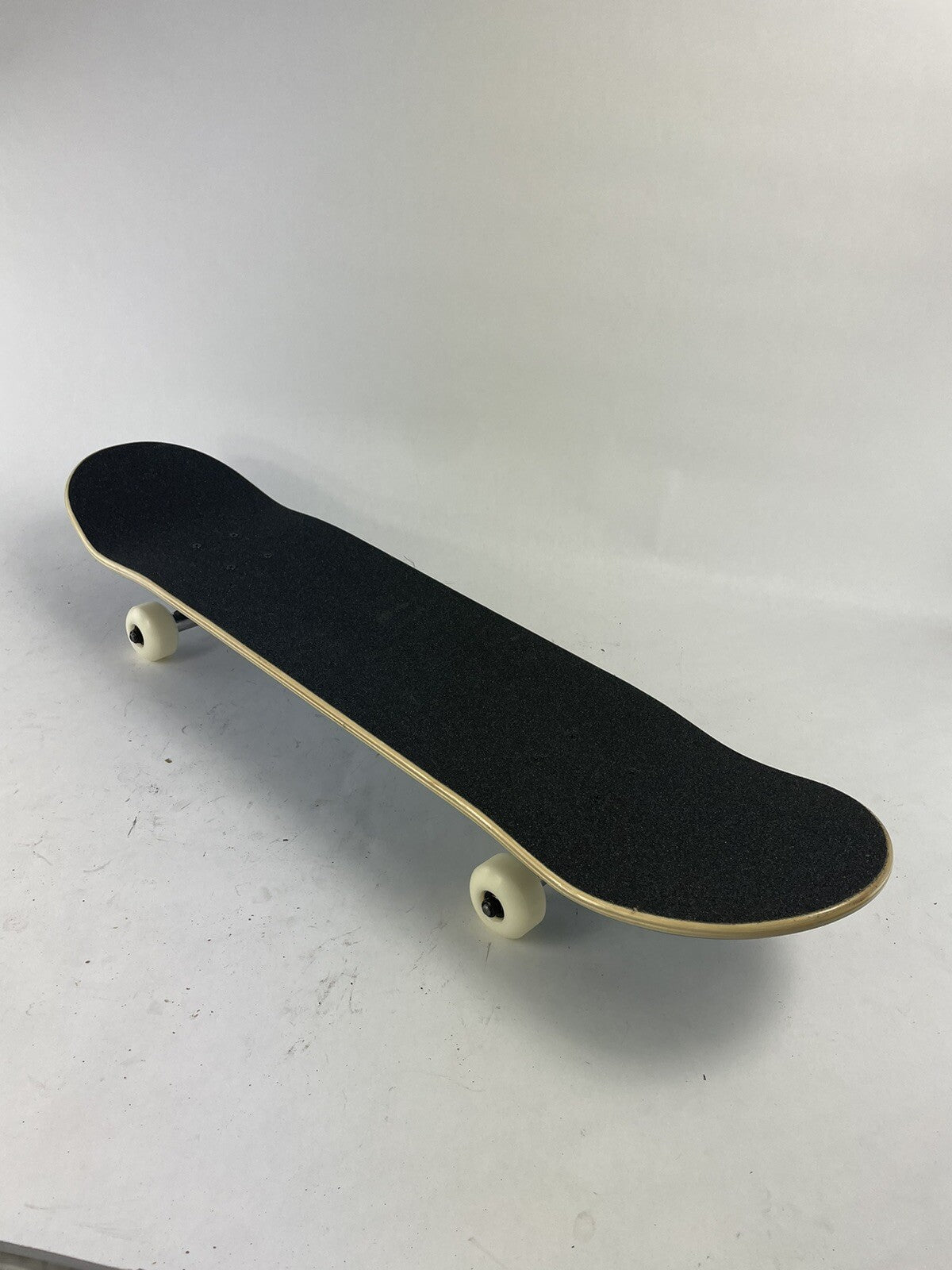 Blue blank 8-inch complete skateboard with gravity cast trucks, 52mm ATM wheels, and ABEC 7 bearings.