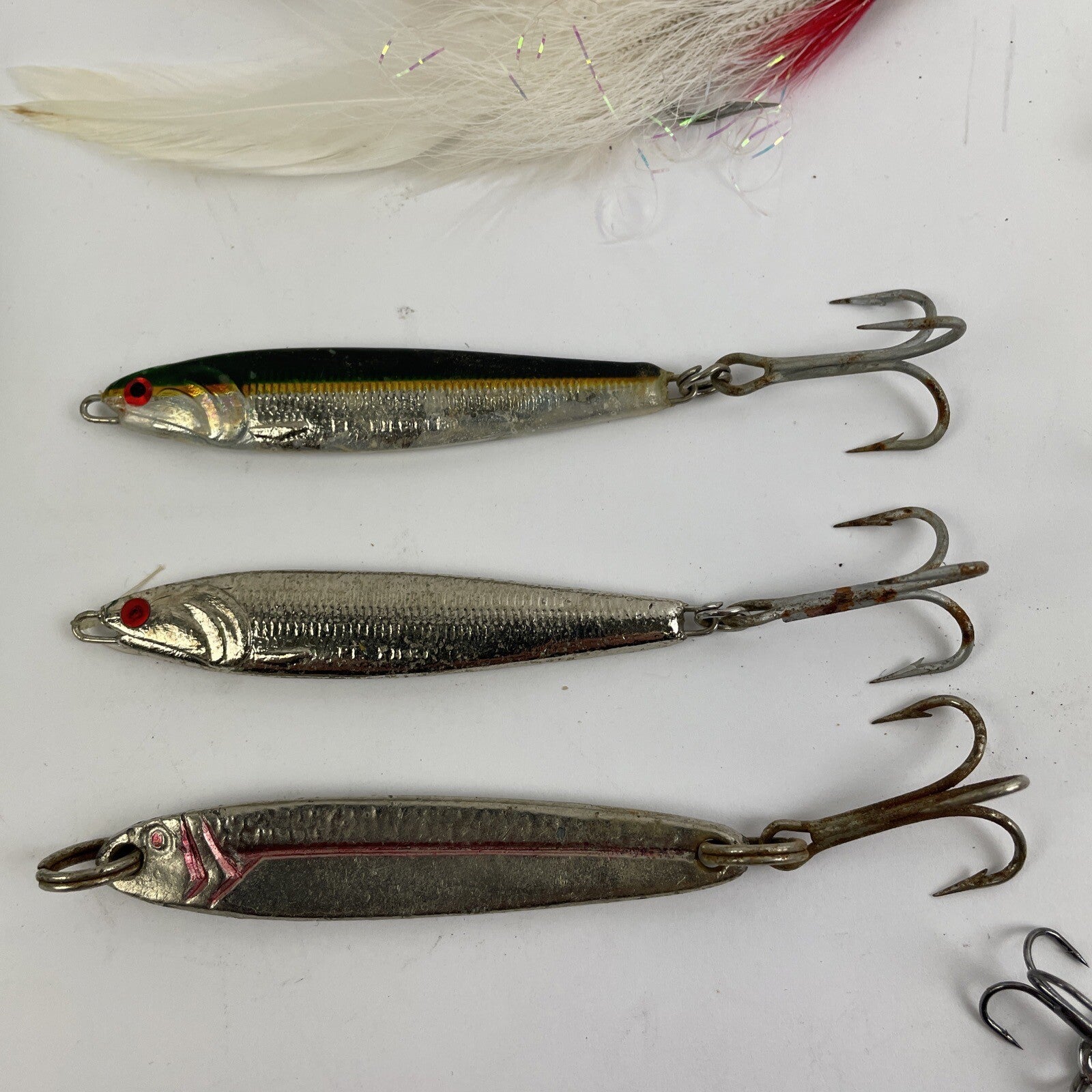 Lot of 22 assorted fishing spoons and spinners including Castmaster, Acme, and Phoebe lures.