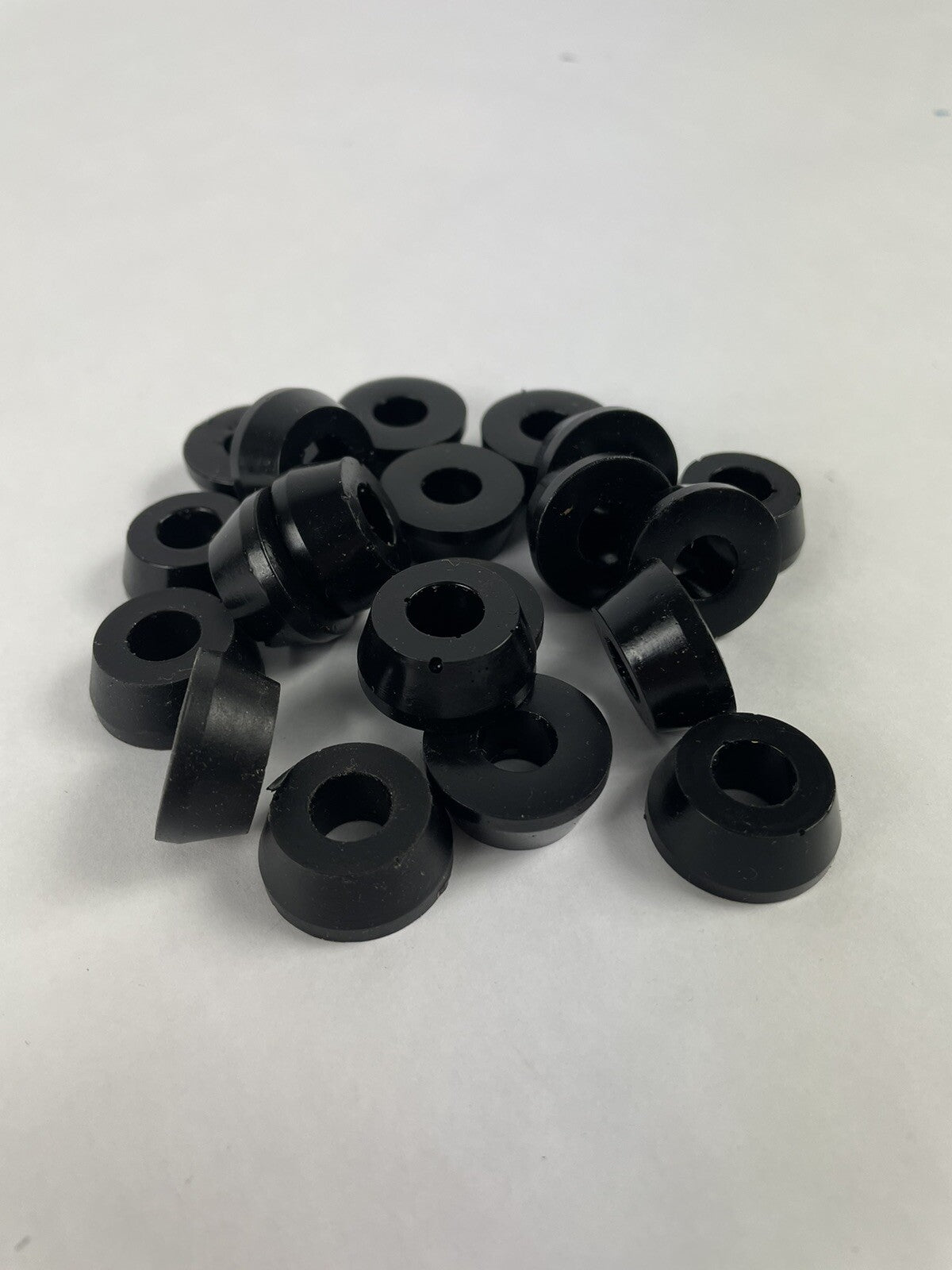 Black skateboard truck upper replacement bushings bulk kit with 20 polyurethane pieces for standard skateboard trucks.