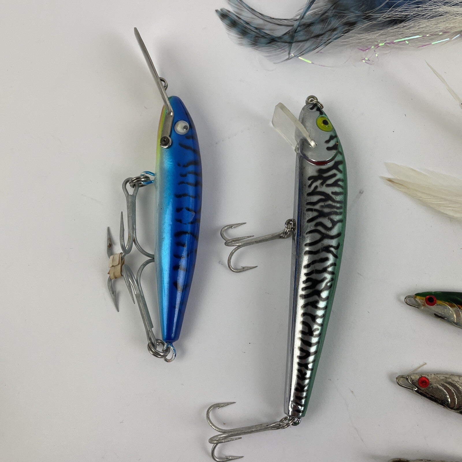 Lot of 22 assorted fishing spoons and spinners including Castmaster, Acme, and Phoebe lures.