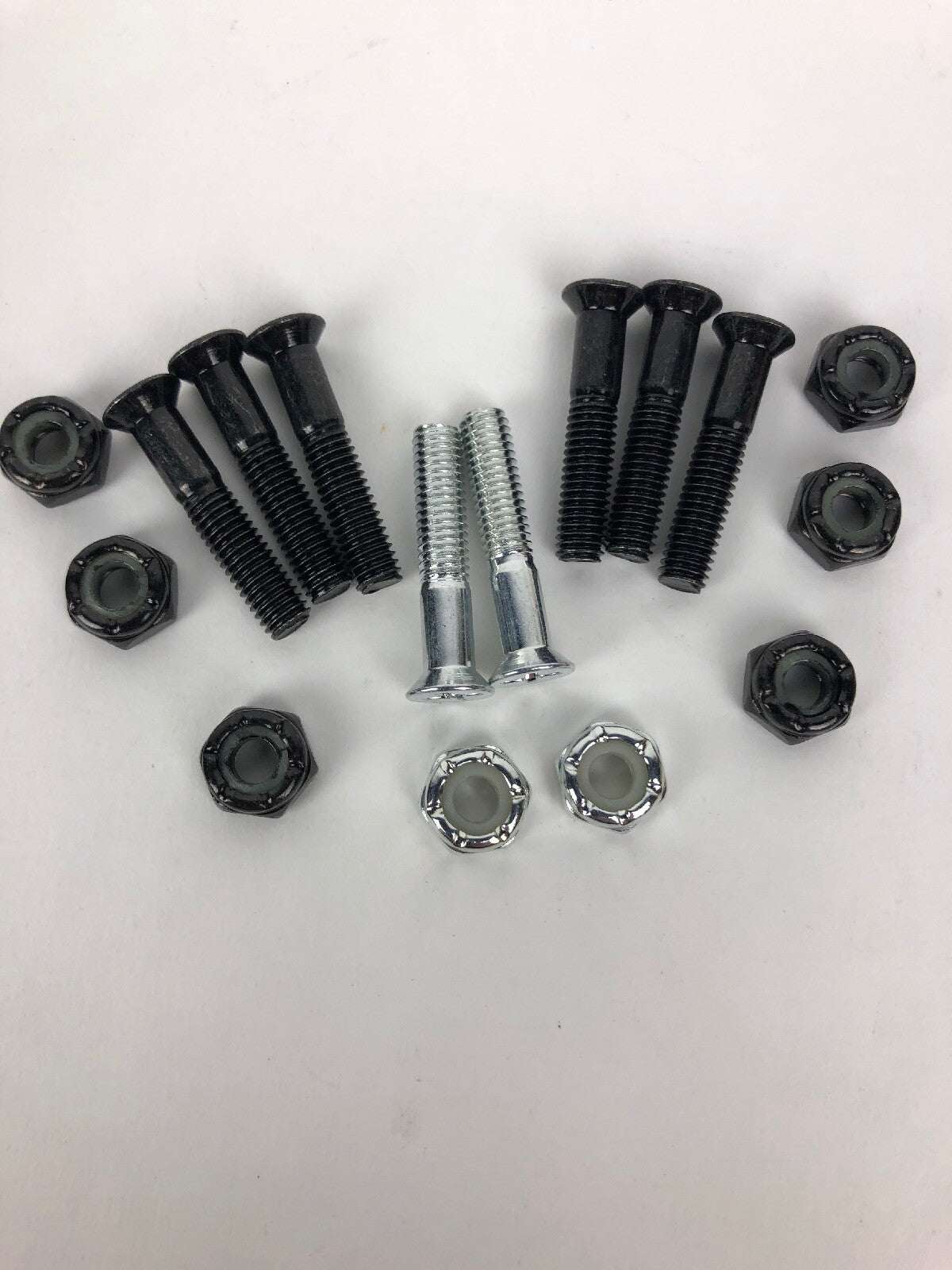 NOS Grind King 1-inch Phillips skateboard hardware set with silver bolts and lock nuts in Silverado finish.
