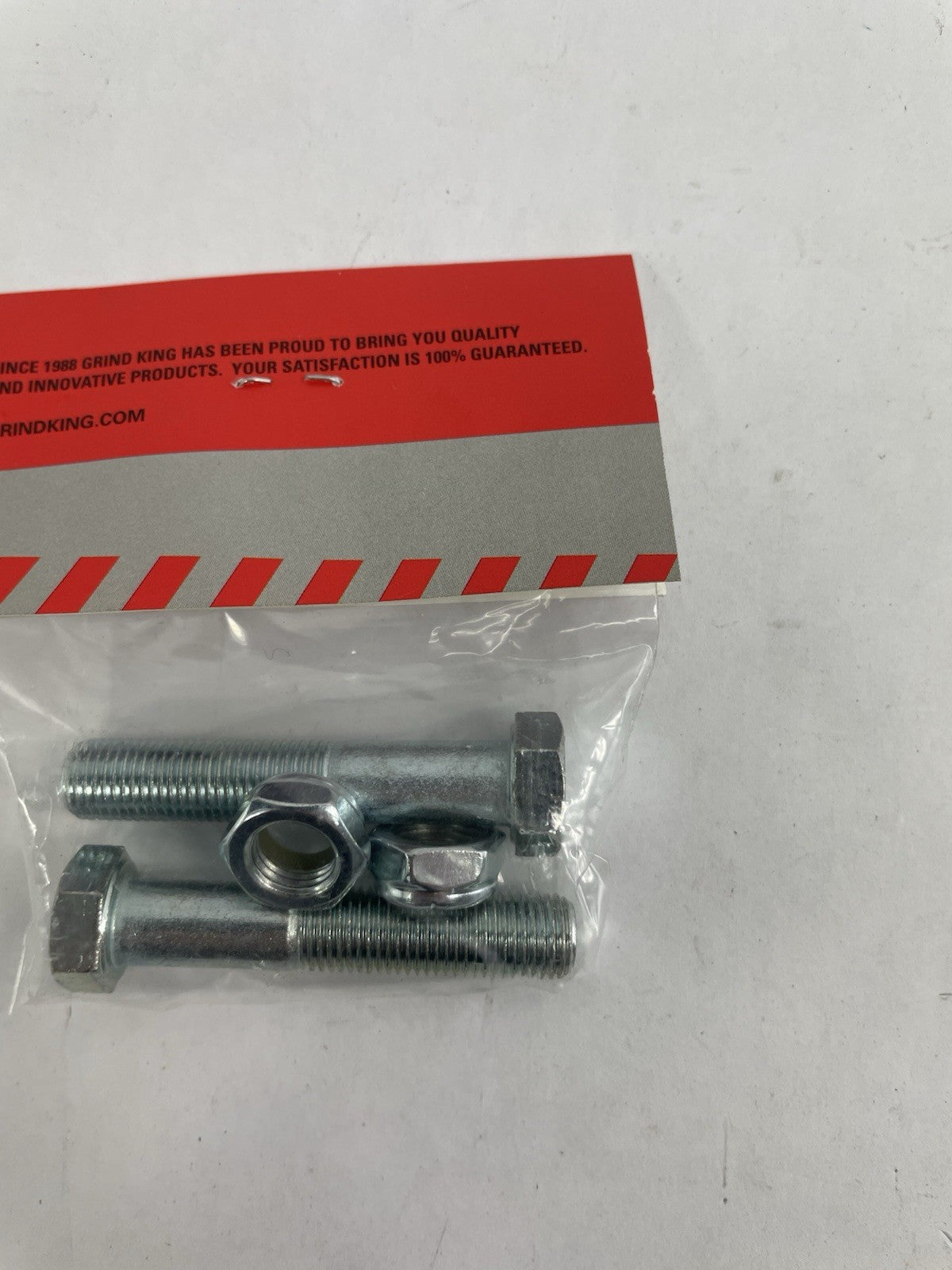 Grind King stainless steel skateboard kingpin set with two locking nuts for regular skateboard truck replacement.