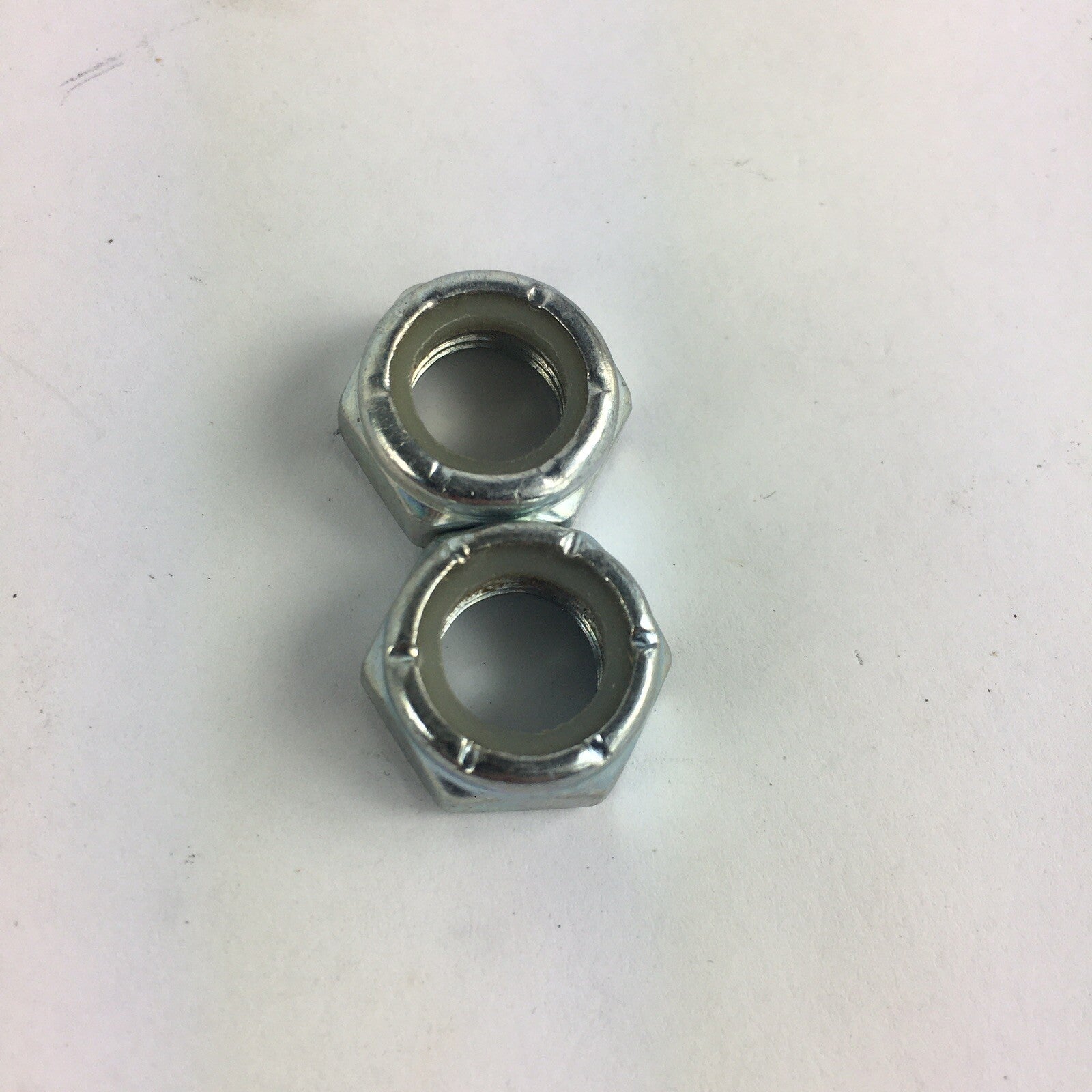 Grind King skateboard truck replacement kingpin lock nuts made from high-strength steel with nylon locking inserts.