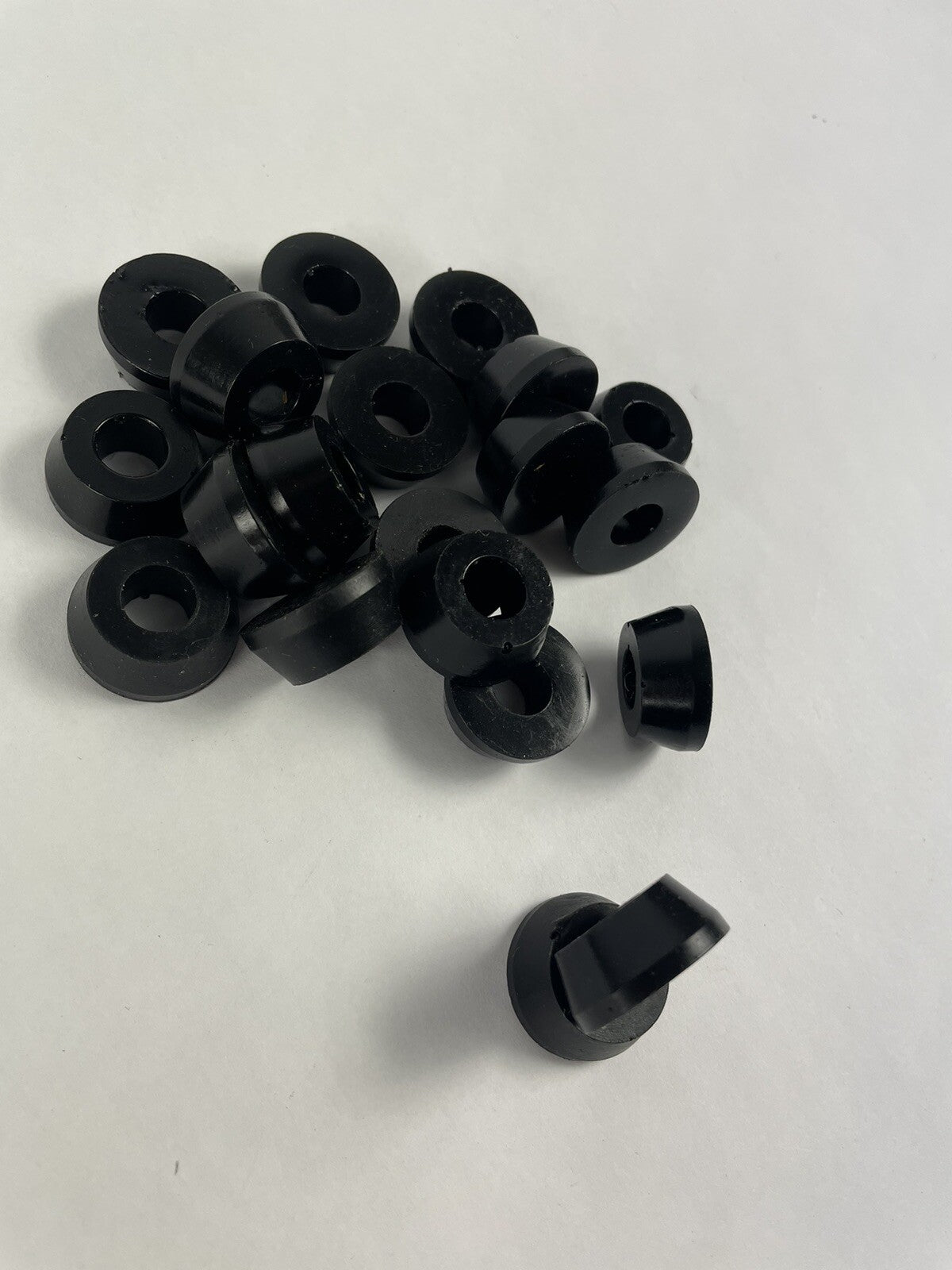 Black skateboard truck upper replacement bushings bulk kit with 20 polyurethane pieces for standard skateboard trucks.