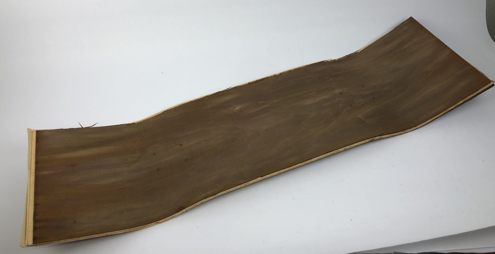 Blank uncut brown stain skateboard deck 10 x 34 inches with 14.25-inch pre-drilled wheelbase.