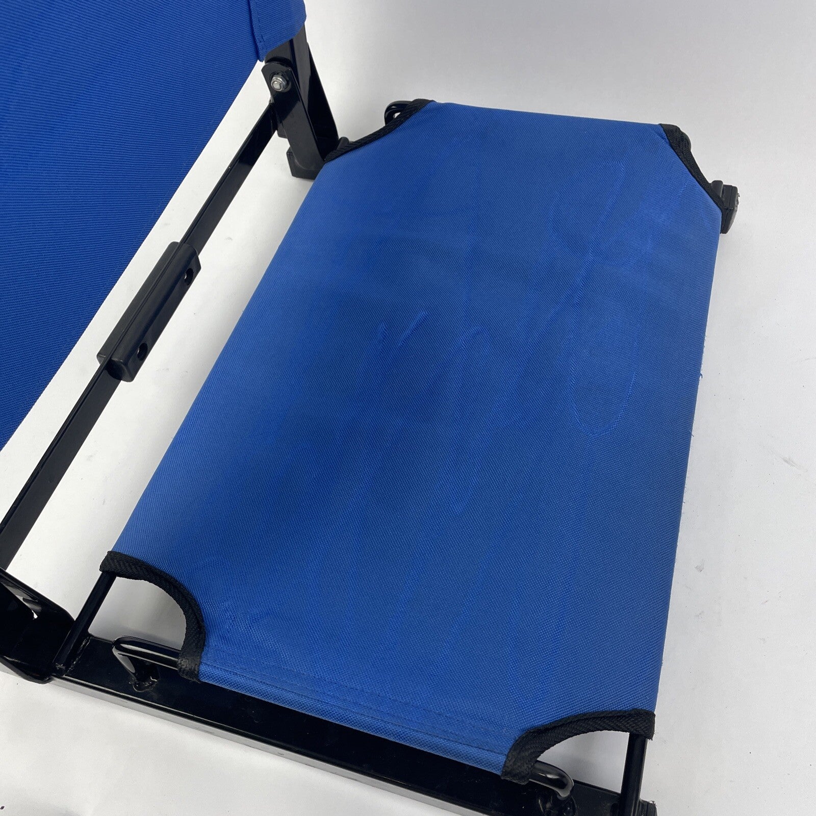 The Stadium Chair Company blue cushioned bleacher seat with EL TORO California branding.