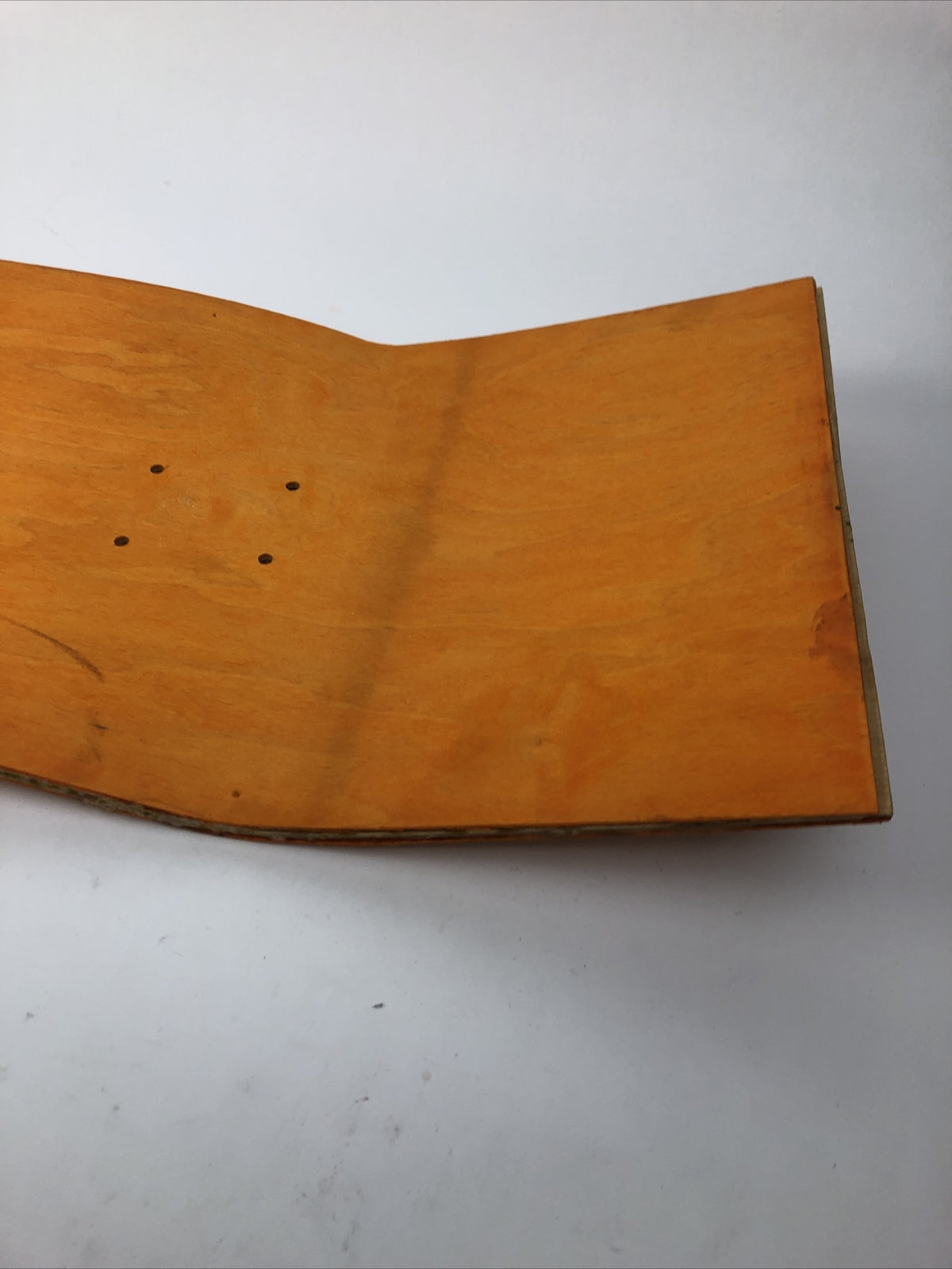 Blank uncut 10 x 34-inch orange stain skateboard deck with 14.25-inch wheelbase.