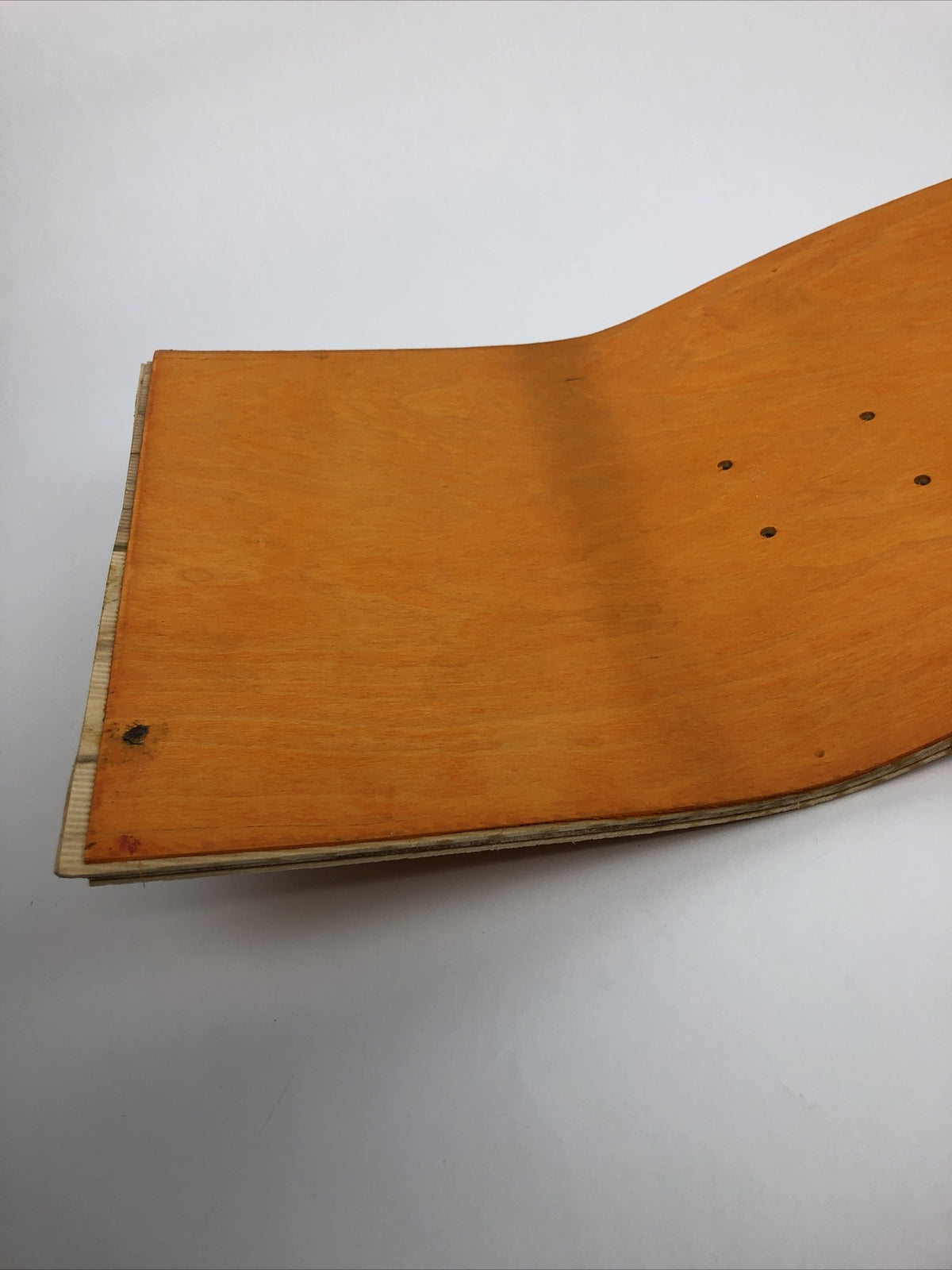 Blank uncut 10 x 34-inch orange stain skateboard deck with 14.25-inch wheelbase.