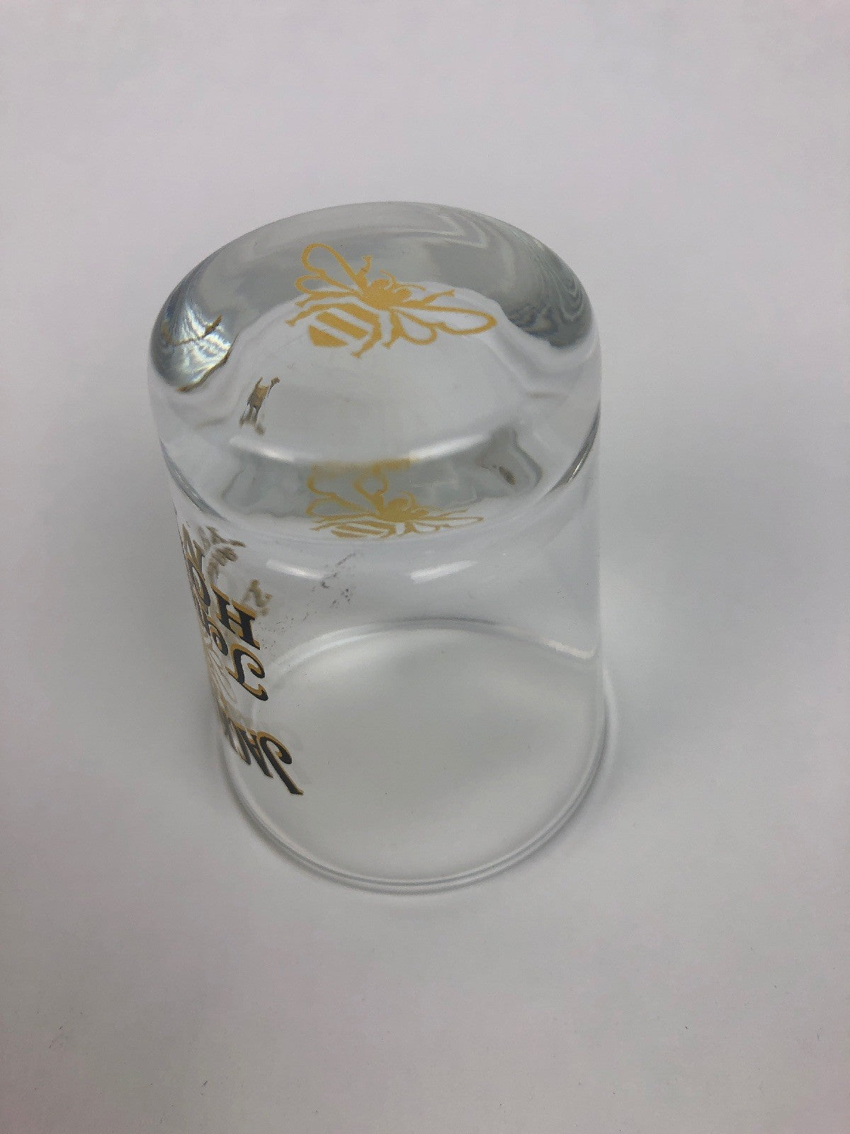 Jack Daniel's Tennessee Honey clear shot glass with gold honey bee design.