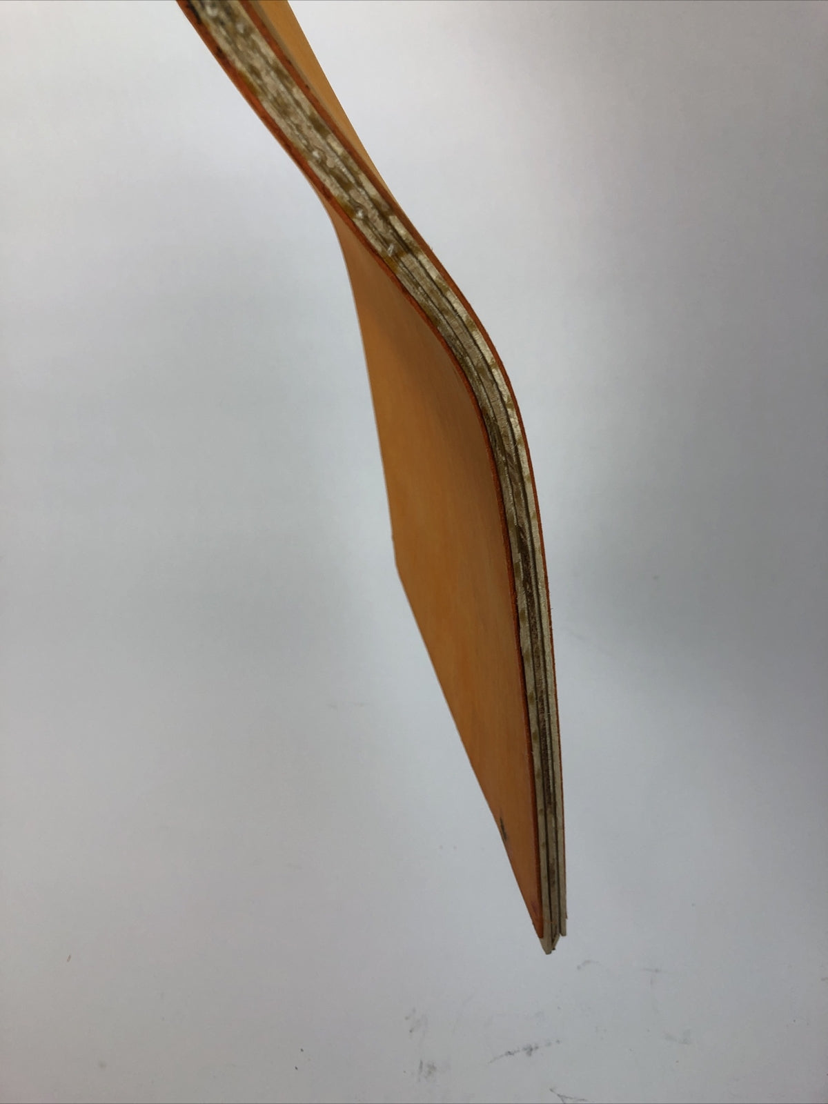 Blank uncut 10 x 34-inch orange stain skateboard deck with 14.25-inch wheelbase.